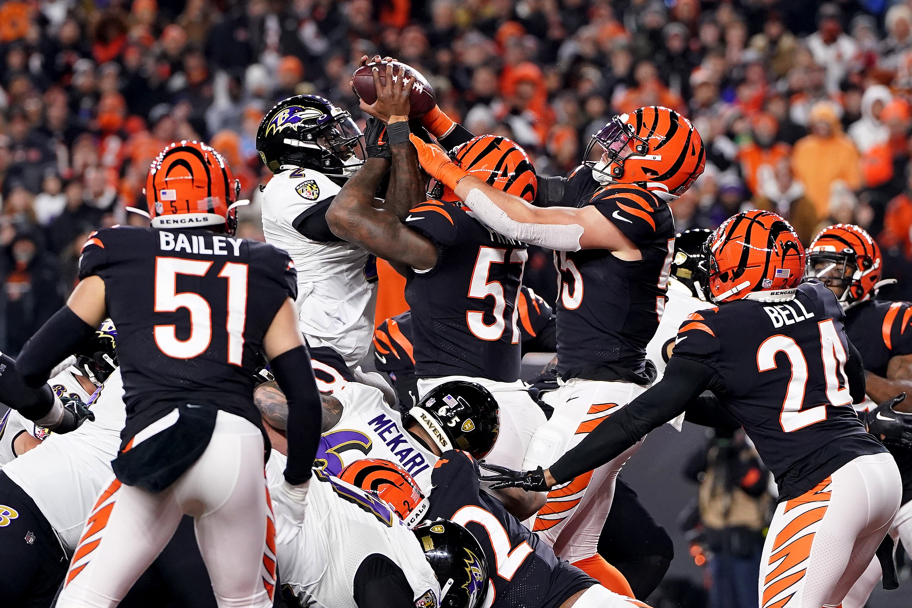 CINCINNATI, OHIO - JANUARY 15: Tyler Huntley #2 of the Baltimore Ravens fumbles the ball that is recovered by Sam Hubbard #94 of the Cincinnati Bengals to score a 98 yard touchdown during the fourth quarter in the AFC Wild Card playoff game at Paycor Stadium on January 15, 2023 in Cincinnati, Ohio. (Photo by Dylan Buell/Getty Images)