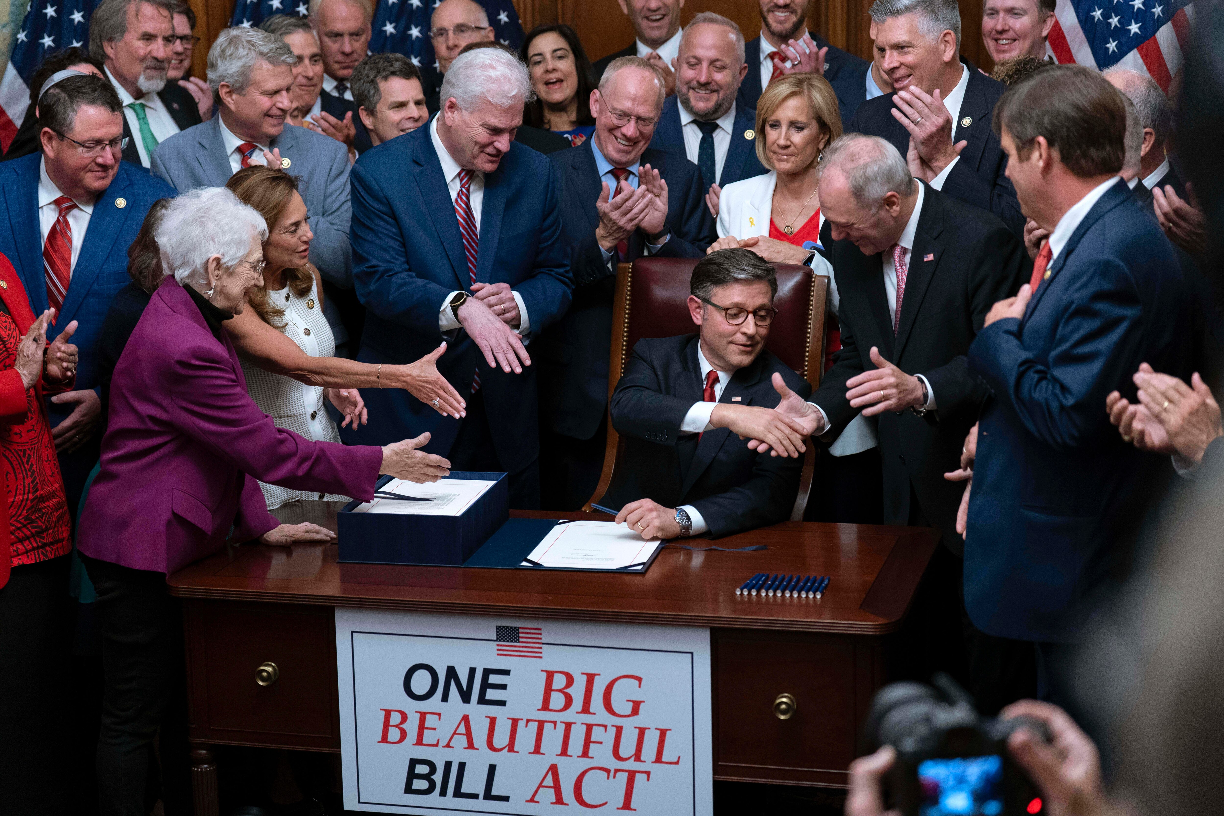 Speaker of the House Mike Johnson, R-La., center, shakes hands with Majority Leader Steve Scalise, R-La., as he celebrates with fellow Republicans after final passage of President Donald Trump's signature bill of tax breaks and spending cuts, at the Capitol in Washington, Thursday, July 3, 2025.