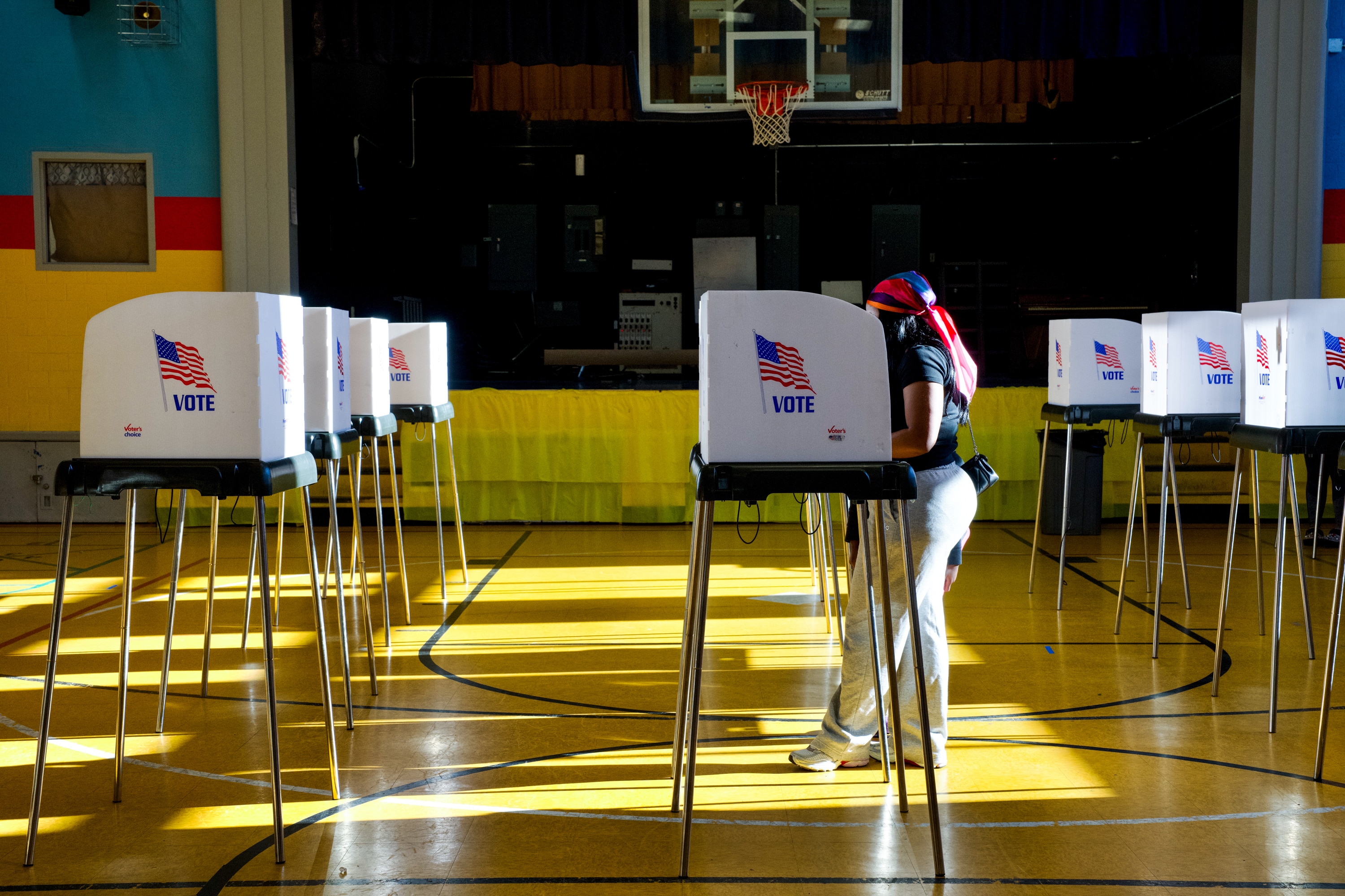People cast their votes at Liberty Elementary, located at 3901 Maine Avenue in Baltimore, on Tuesday. At 6:30 p.m., the polling location was empty save for a few voters.