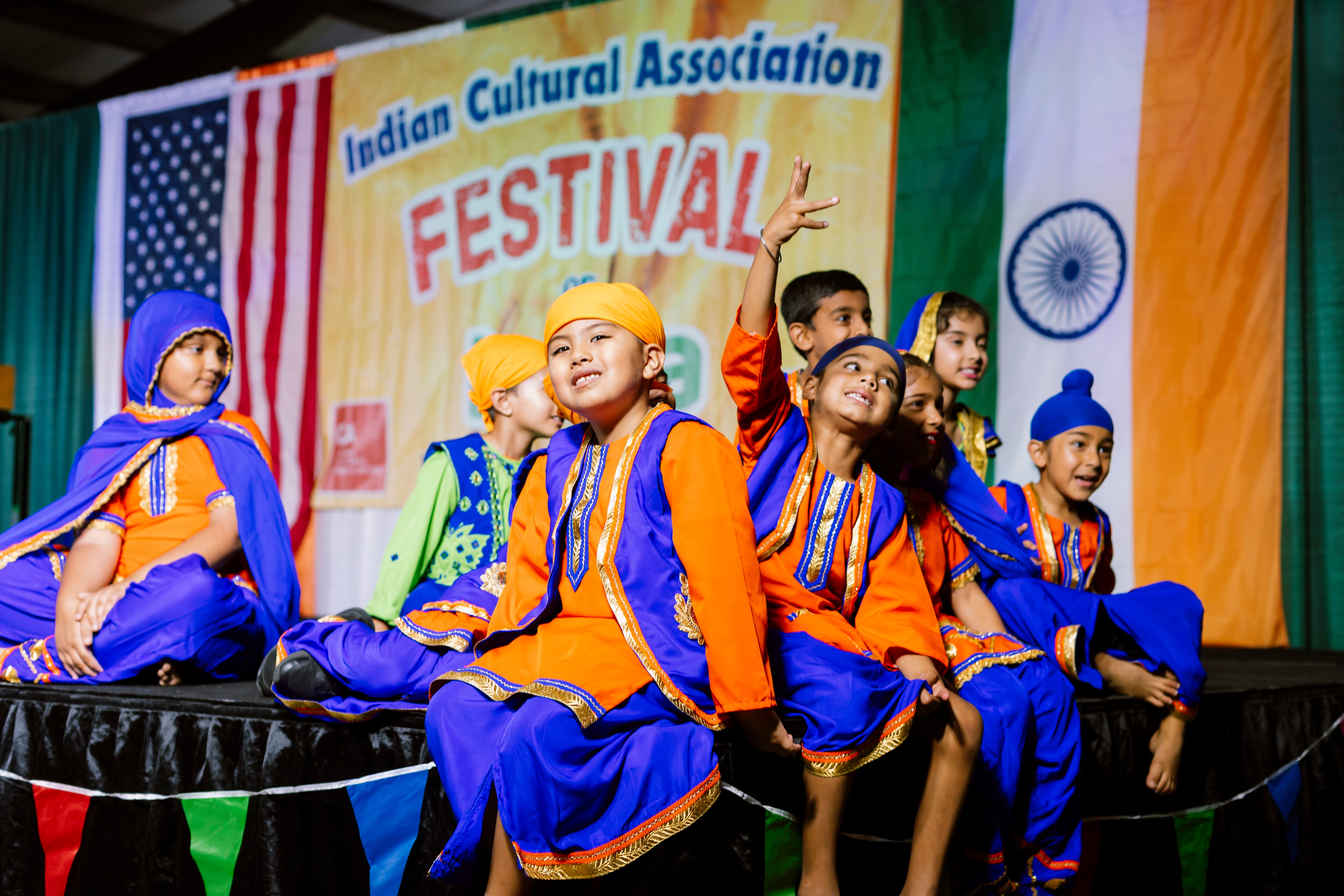 Youth performers pose for pictures on stage before performing during the Festival of India at the Howard County Fairgrounds on Saturday, Sept. 21, 2024 in West Friendship, MD.