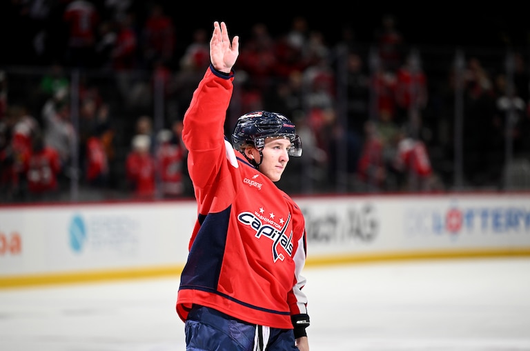 Cole Hutson #44 of the Washington Capitals waves to the crowd after being named the third star of the game in his NHL debut against the Ottawa Senators at Capital One Arena on March 18, 2026 in Washington, D.C.