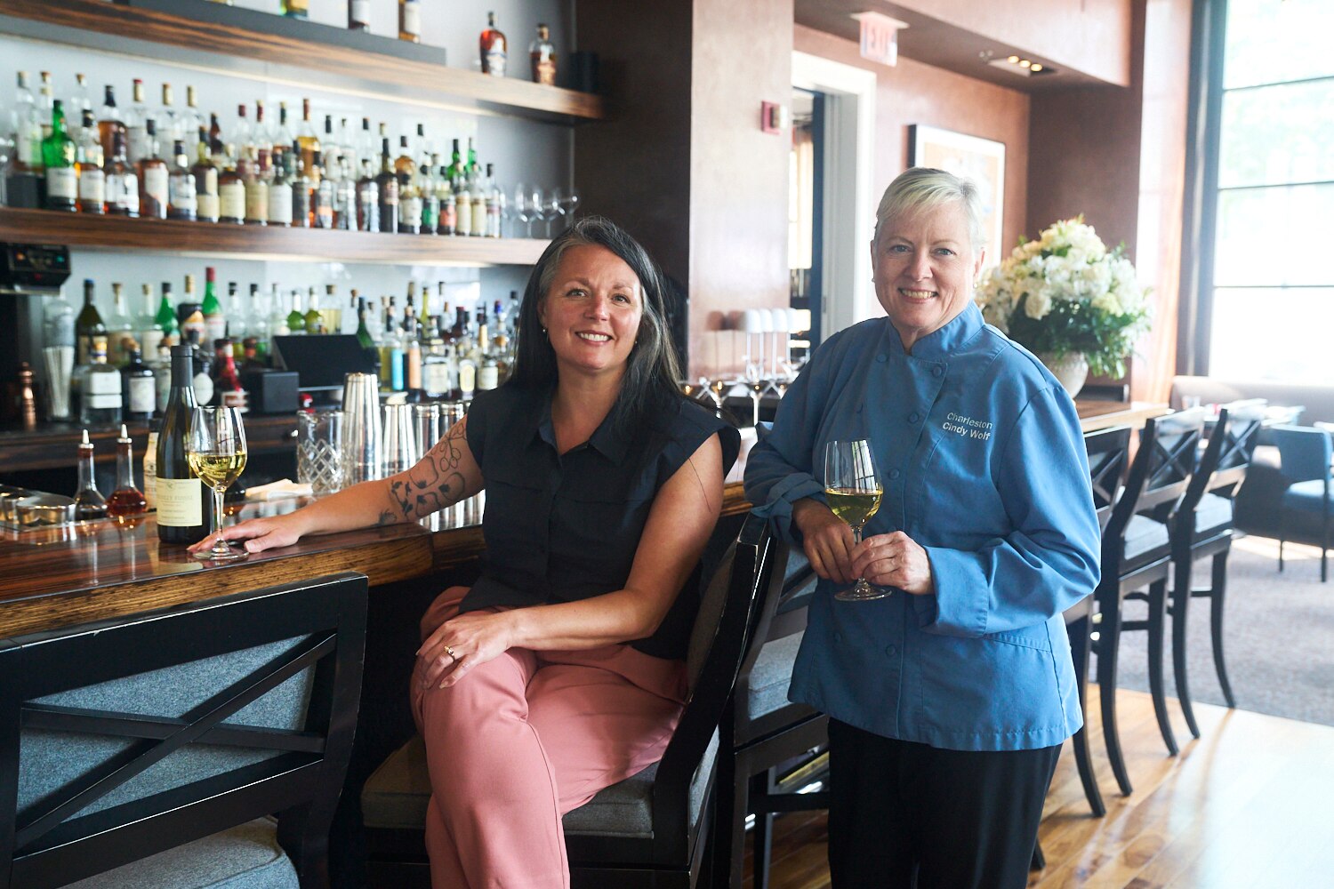 Chef Cindy Wolf, right, and wine director Lindsay Willey at the bar at Charleston in Harbor East.