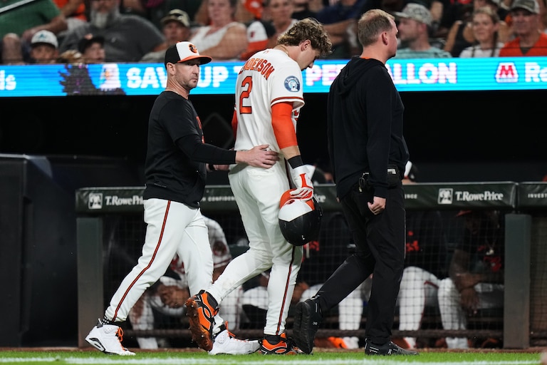 Orioles shortstop Gunnar Henderson leaves the field with manager Craig Albernaz, left, and a trainer after an injury during the eighth inning.