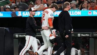 Orioles shortstop Gunnar Henderson leaves the field with manager Craig Albernaz, left, and a trainer after an injury during the eighth inning.