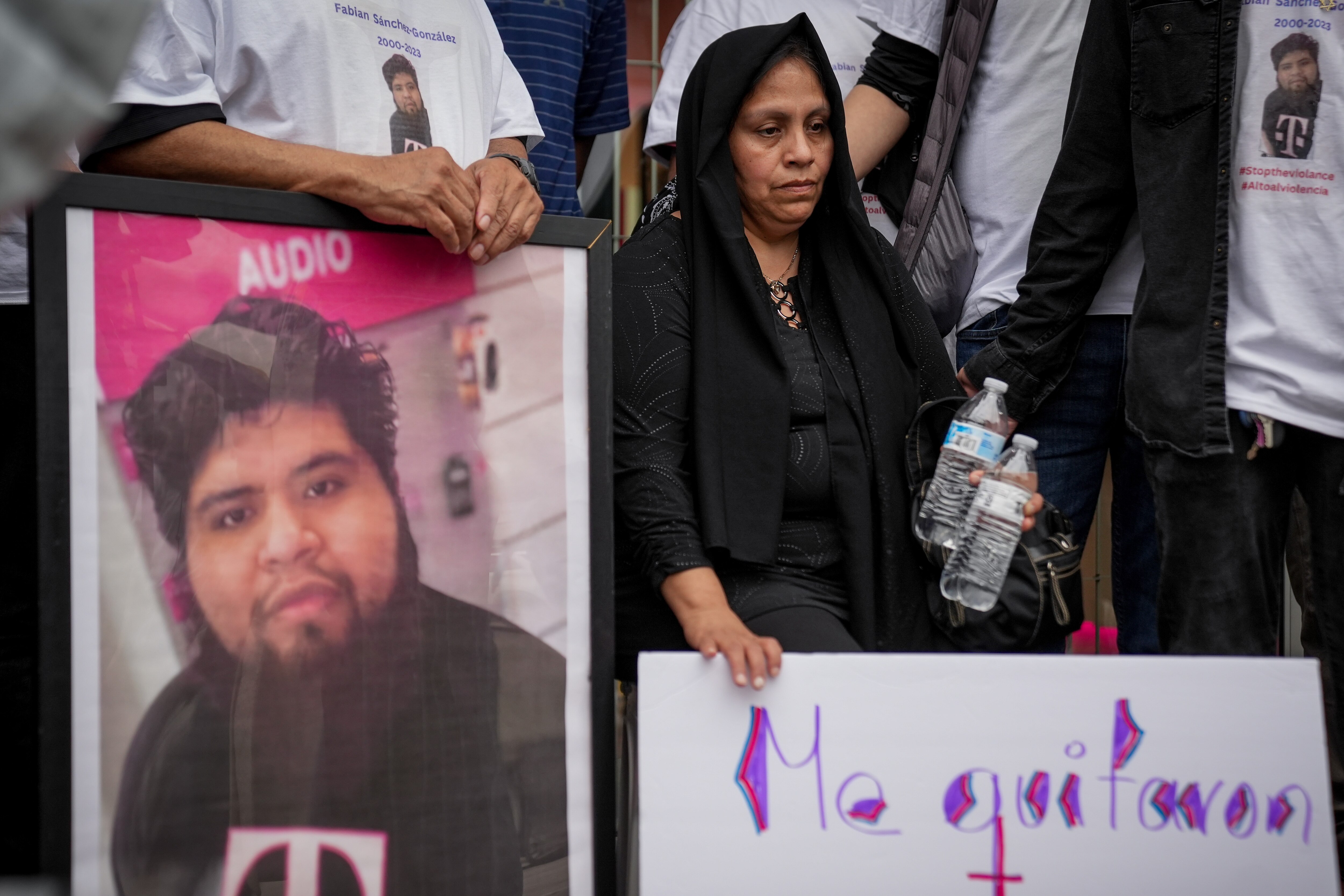 Alma González sits surrounded by family and loved ones at a vigil for her son, Fabián Alberto Sánchez González, on Sunday, May 7. She holds a sign that translates to “they took my son from me” in English. The 23-year-old was shot during an armed robbery at a T-Mobile store in Canton where he worked, and died one day later at Johns Hopkins Bayview Medical Center.