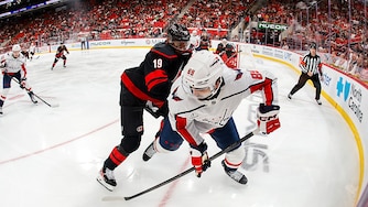 Alex Tuch #89 of the Washington Capitals skates with the puck guarded by K'andre Miller #19 of the Carolina Hurricanes during the second period.