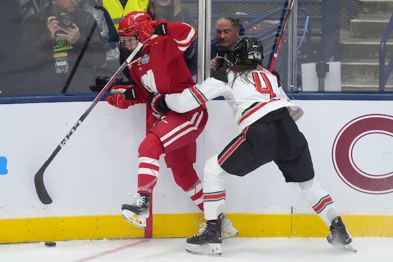 Wisconsin forward Lacey Eden (6) and Ohio State defenseman Stephanie Markowski (4) pursue the puck in the first period of an NCAA college women's championship hockey game, Sunday, March 24, 2024, in Durham, N.H. (AP Photo/Steven Senne)