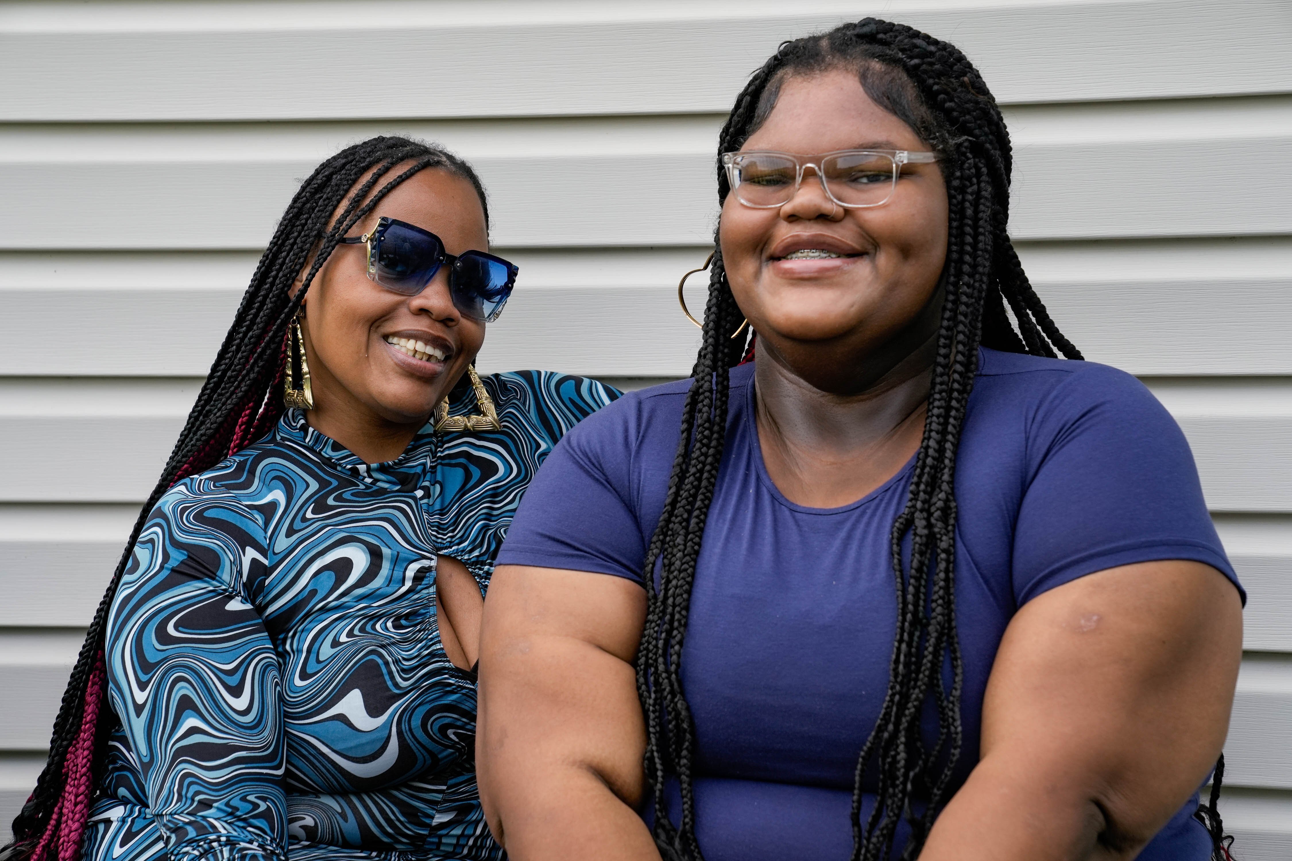 Laseanya Darby, 20, sits on her back porch with her mother, Rana Young. Darby was treated through the Mount Washington Pediatric Hospital's Weigh Smart Program starting at age 7 and had bariatric surgery as an adult.