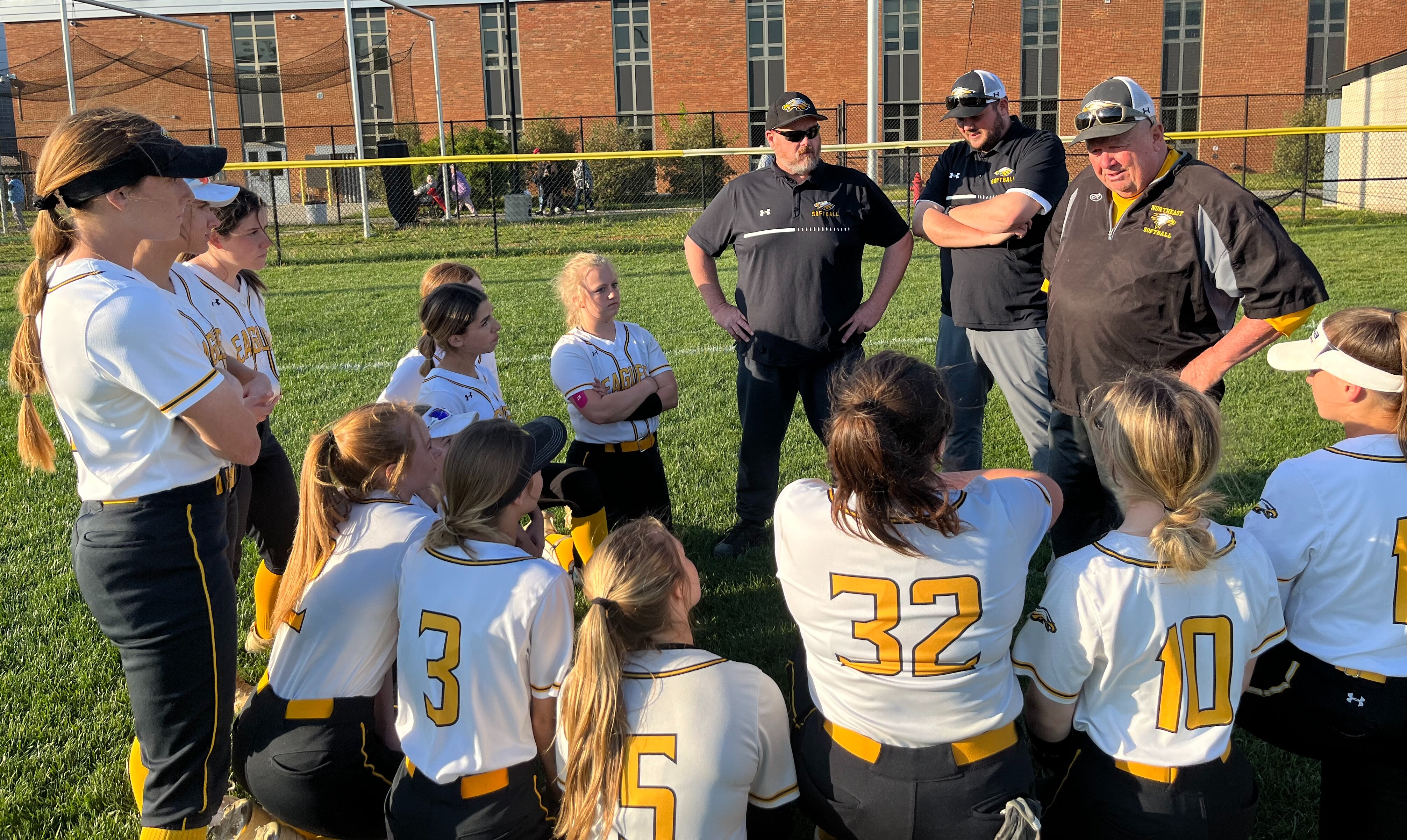 Northeast softball coach Joe Hart (right) talks to his team after Monday's victory over Arundel. The third-ranked Eagles improve to 7-0 in Anne Arundel County with a 4-1 decision over No. 11 Arundel in Pasadena.