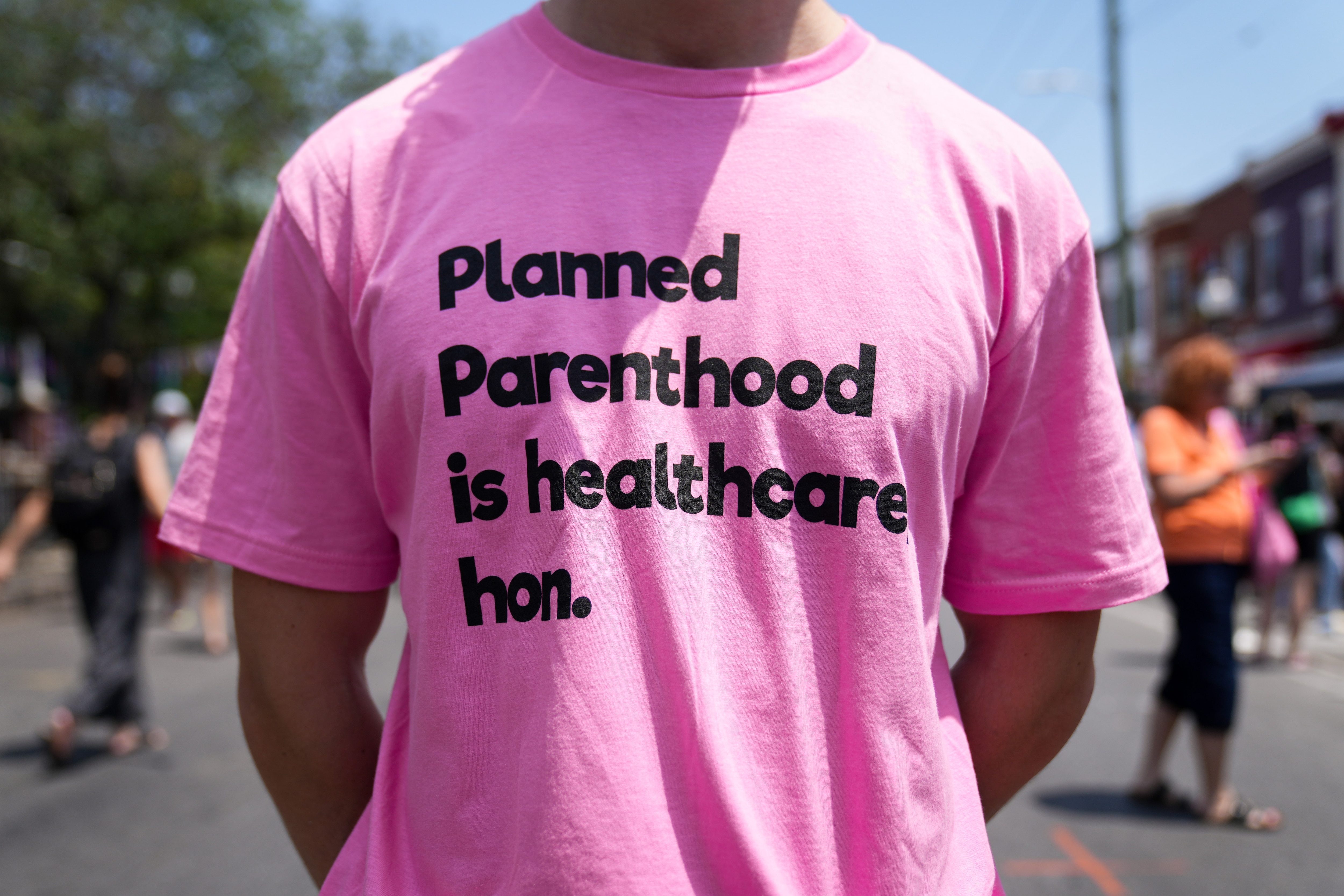 A man wears a T-shirt on Saturday supporting Planned Parenthood at HonFest 2023 in Hampden. Planned Parenthood of Maryland, a nonprofit organization that provides low-cost reproductive health care services, including abortions, last week announced that festival organizers had denied its application to be a vendor at the event, sparking a firestorm on social media. Event organizers backtracked and apologized.