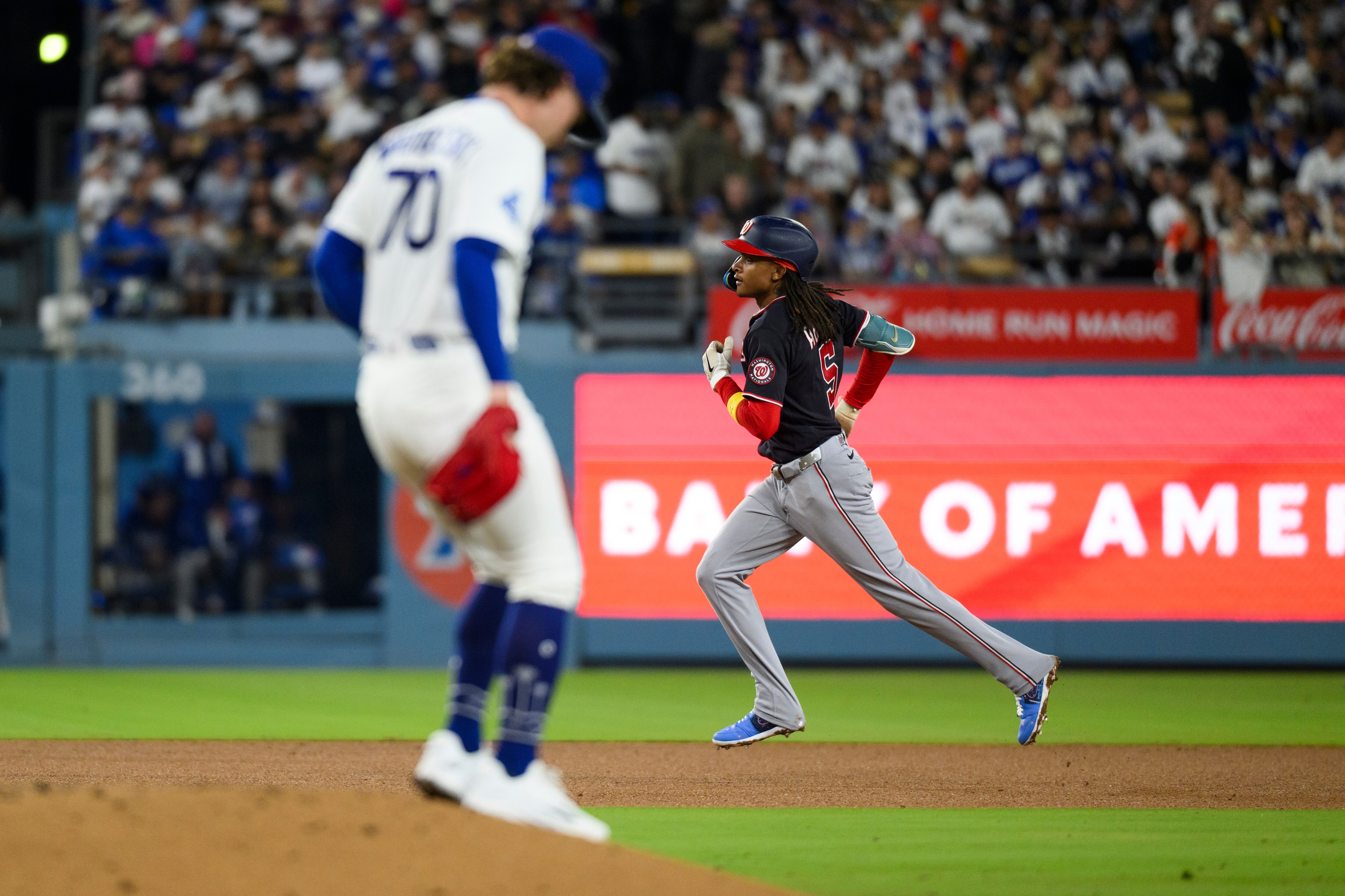 Washington Nationals' CJ Abrams, right, rounds the bases after hitting a solo home run during the fourth inning of a baseball game against the Los Angeles Dodgers in Los Angeles, Sunday, Sept. 6, 2026. (AP Photo/Kyusung Gong)