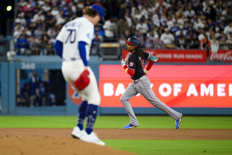 Washington Nationals' CJ Abrams, right, rounds the bases after hitting a solo home run during the fourth inning of a baseball game against the Los Angeles Dodgers in Los Angeles, Sunday, Sept. 6, 2026. (AP Photo/Kyusung Gong)
