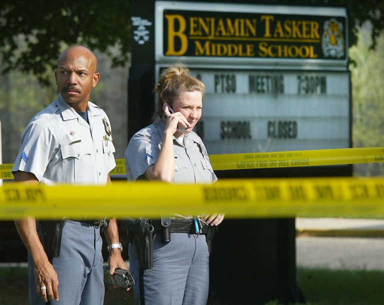 Prince Georges County police officers stand in front of Benjamin Tasker Middle School October 7, 2002 in Bowie, Maryland.