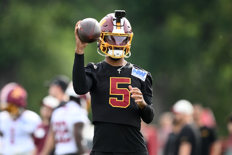 Washington Commanders quarterback Jayden Daniels (5) works out during practice at the team's NFL football training camp, Saturday, Aug. 1, 2026 in Ashburn, Va. (AP Photo/Nick Wass)
