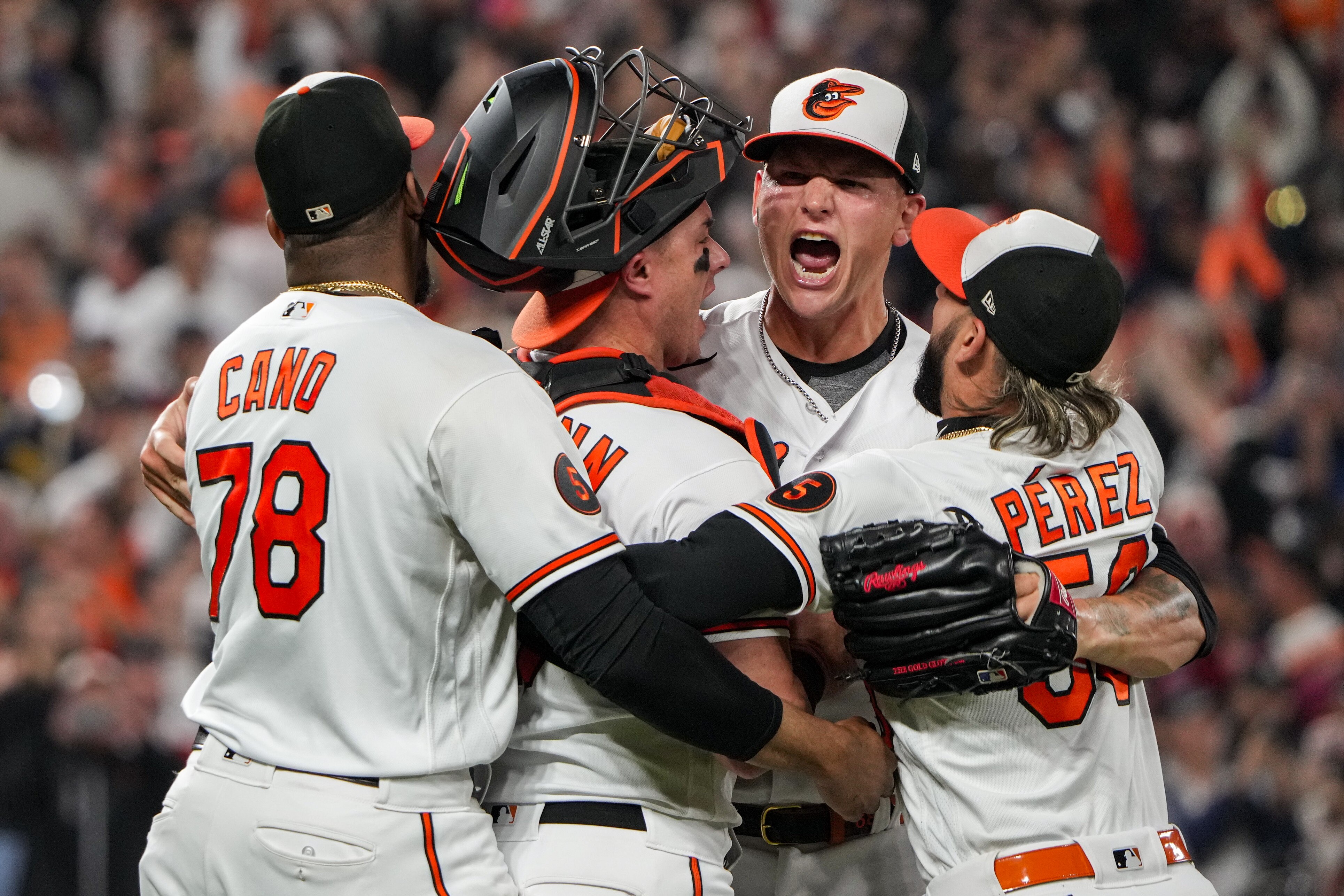 Orioles relief pitcher Tyler Wells is swarmed by teammates after getting the last out of Thursday night's 2-0 victory over the Boston Red Sox at Camden Yards.