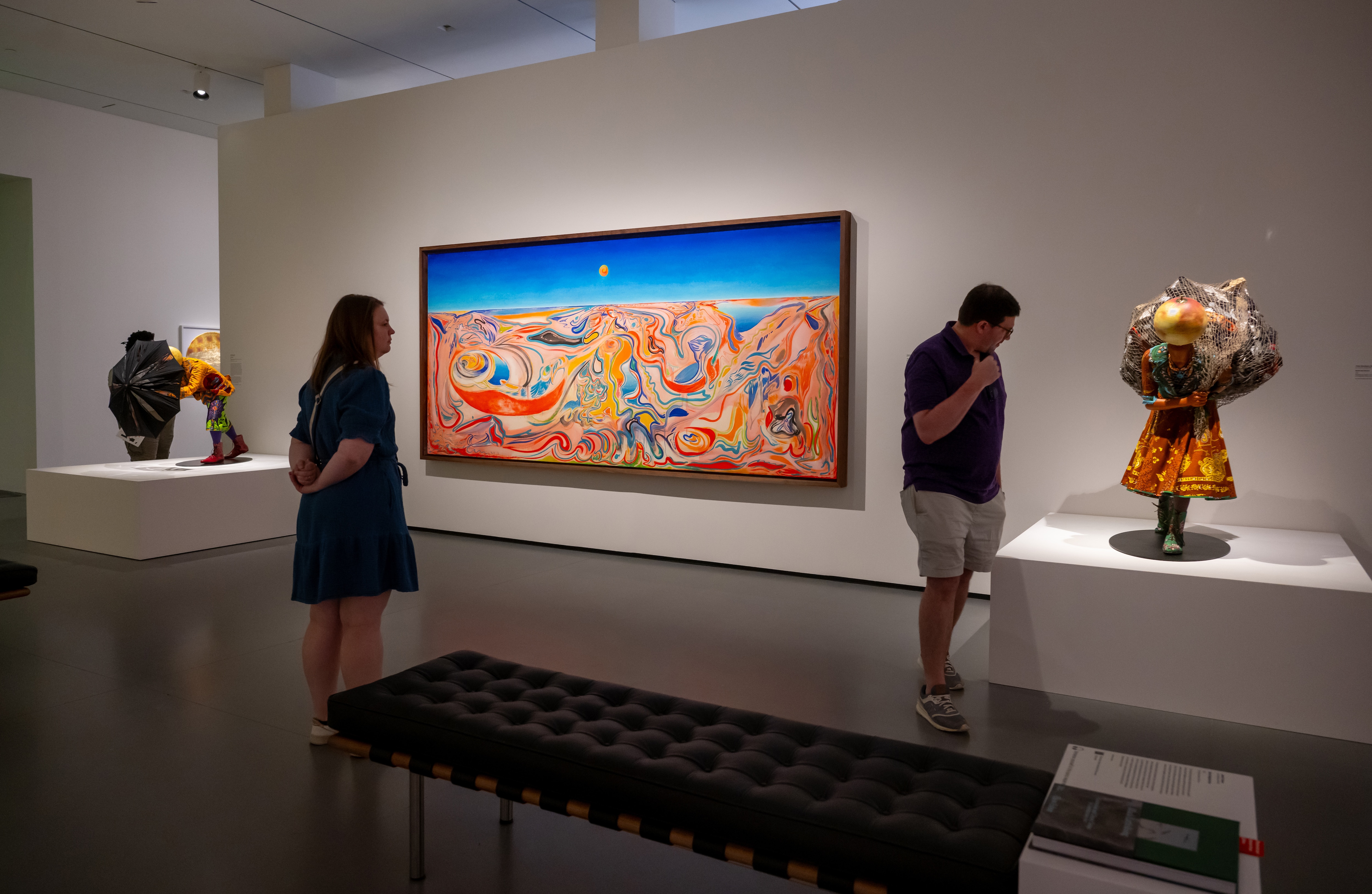 The Baltimore Museum of Art’s “Black Earth Rising” exhibit features ”Viajando En La Franja Del Iris,” an oil painting on linen by Cuba-born artist Alejandro Piñeiro Bello (center).