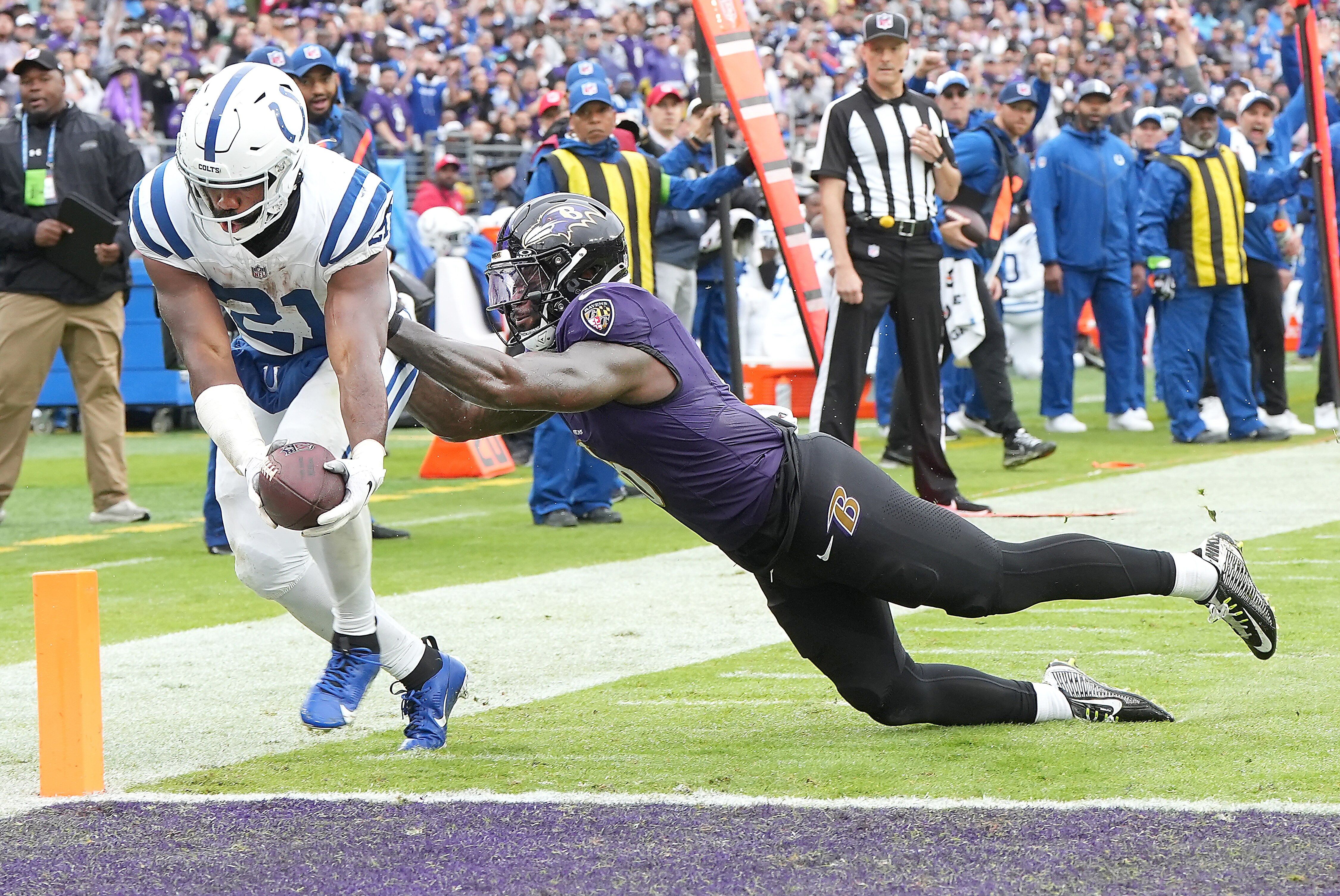 Indianapolis running back Zack Moss scores a receiving touchdown before Ravens linebacker Patrick Queen can stop him during last week's Colts victory in overtime.