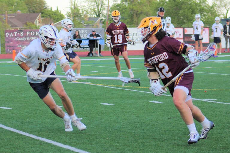 Hereford's Baylor Davis goes on the attack against Catonsville defensemen William Robertson during the third quarter of Monday's Baltimore County boys lacrosse contest. Davis scored all five of his goals in the first half as the Bulls defeated the host Comets, 15-4, in a rematch of last spring's Baltimore County final.
