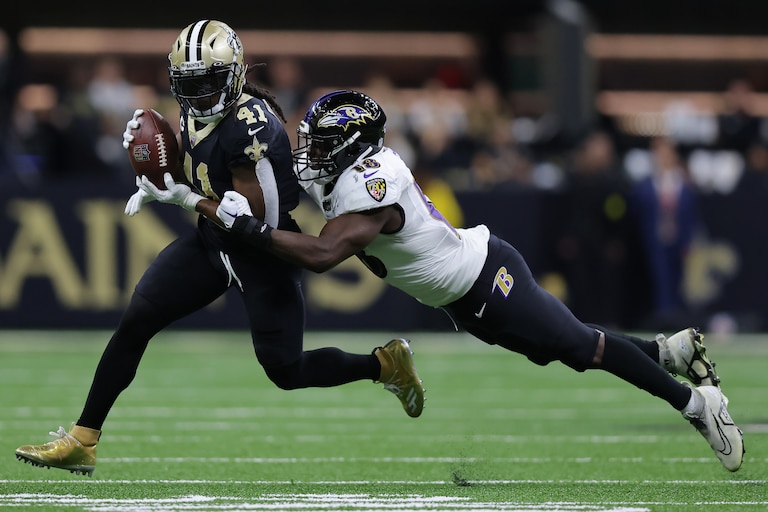 NEW ORLEANS, LOUISIANA - NOVEMBER 07: Alvin Kamara of the New Orleans Saints is tackled by Roquan Smith of the Baltimore Ravens during the second quarter at Caesars Superdome on November 07, 2022 in New Orleans, Louisiana.