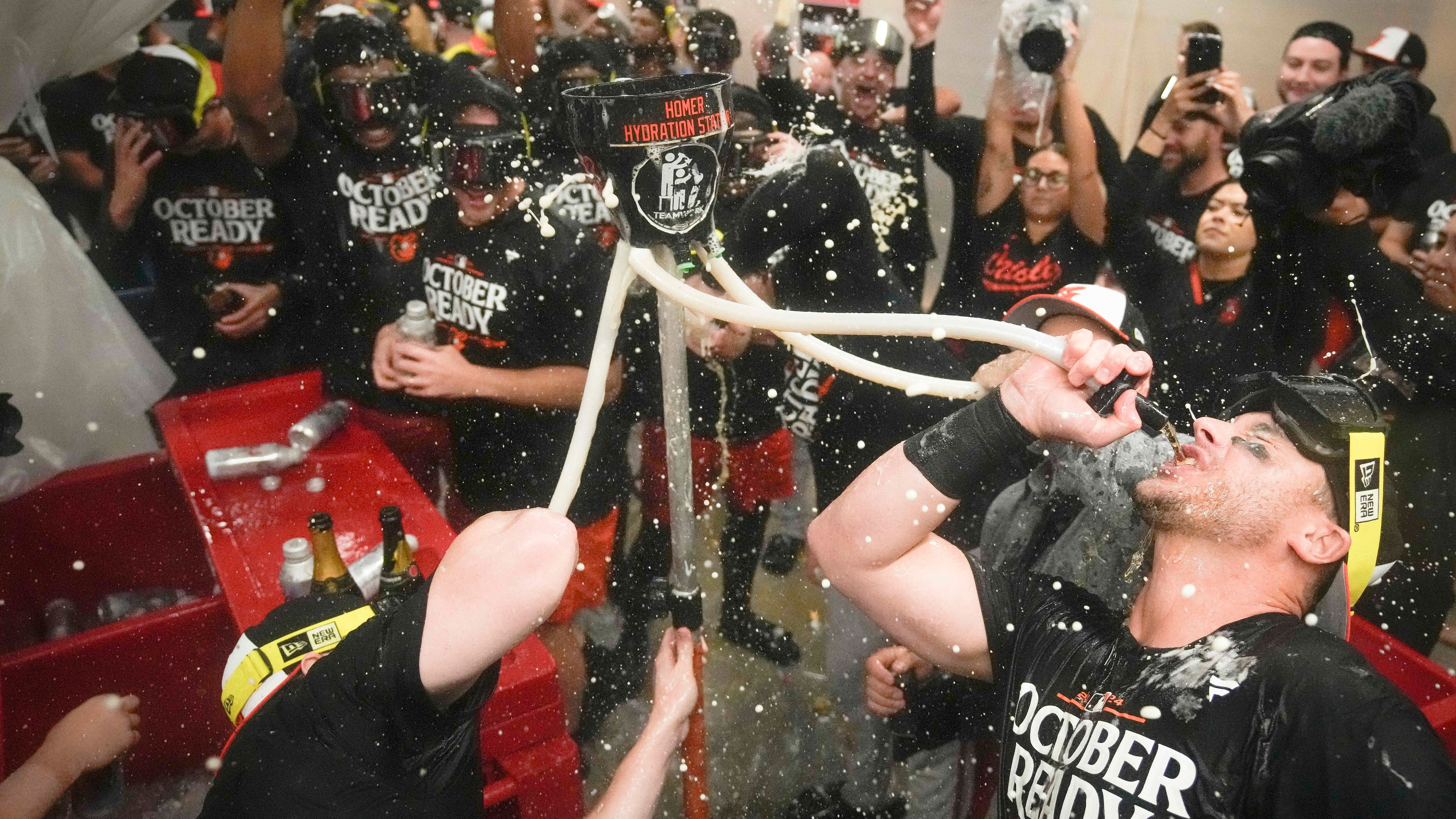 Baltimore Orioles' players celebrate after clinching a playoff berth by defeating the New York Yankees in baseball game, Tuesday, Sept. 24, 2024, in New York. (AP Photo/Bryan Woolston)