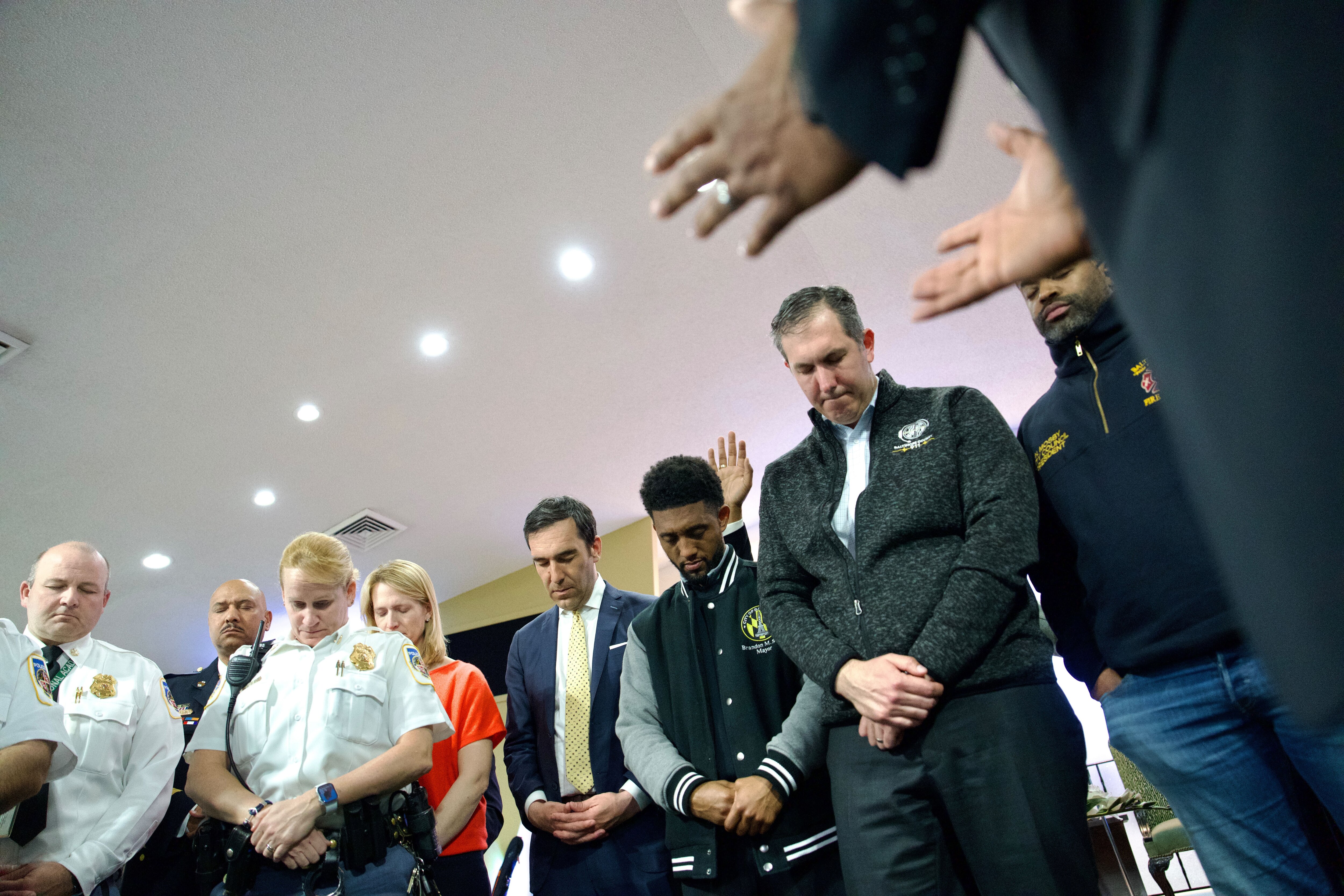Mayor Brandon Scott, Johnny Olszewski, and community members react to the news and grief of loss during a vigil at Mt. Olive Baptist Church of Turner Station.