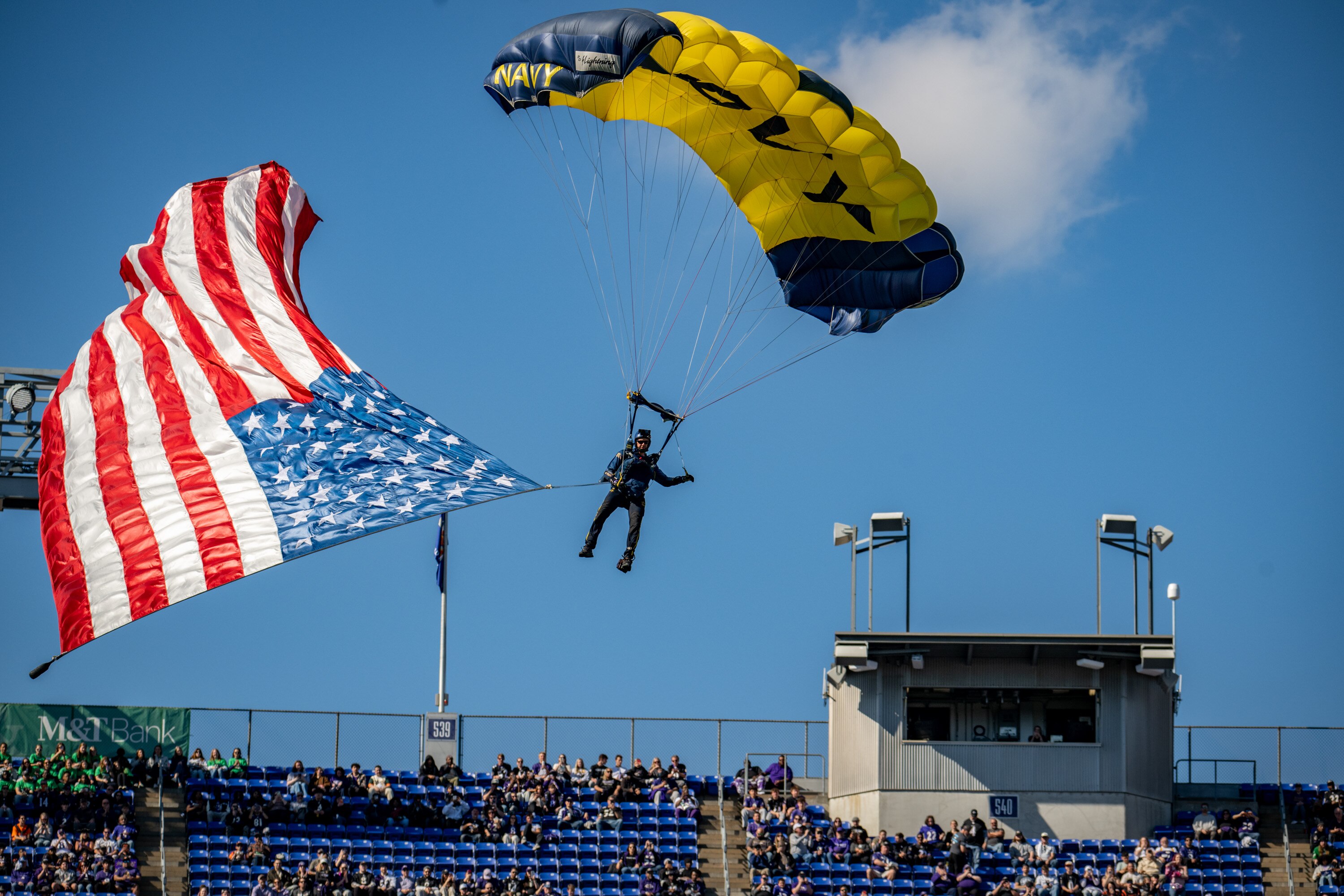 A member of the Navy Leap Frogs parachutes into M&T Bank Stadium Saturday before the Baltimore Ravens host the Cincinnati Bengals. 