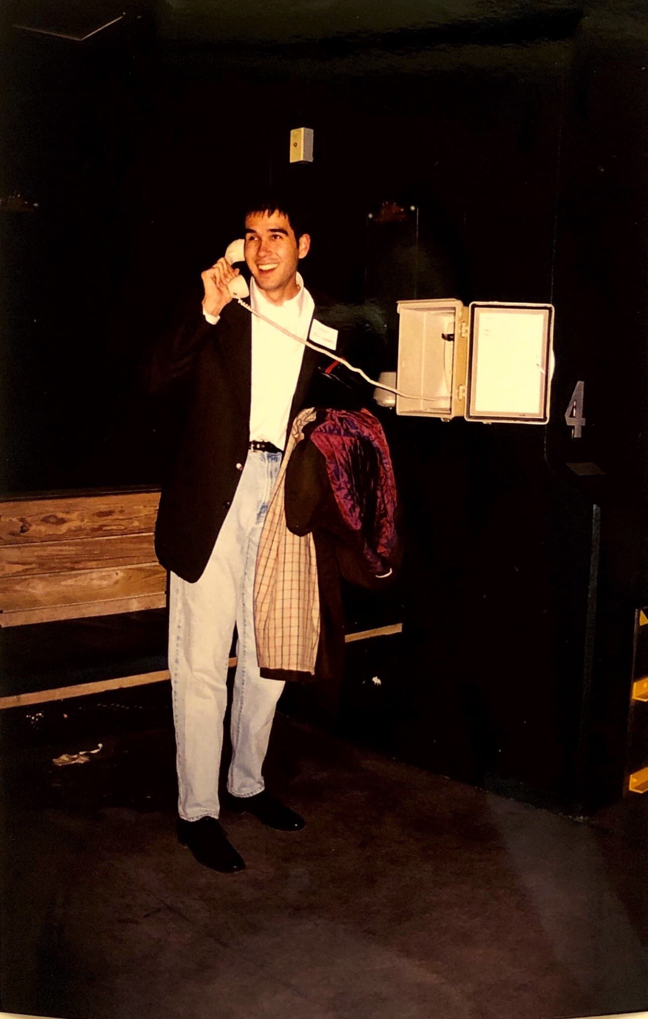 Bill Warren poses with a phone in the Orioles dugout.