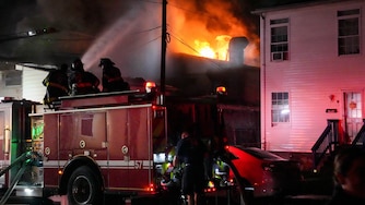 Baltimore firefighters battle a four-alarm fire in South Baltimore on Saturday.