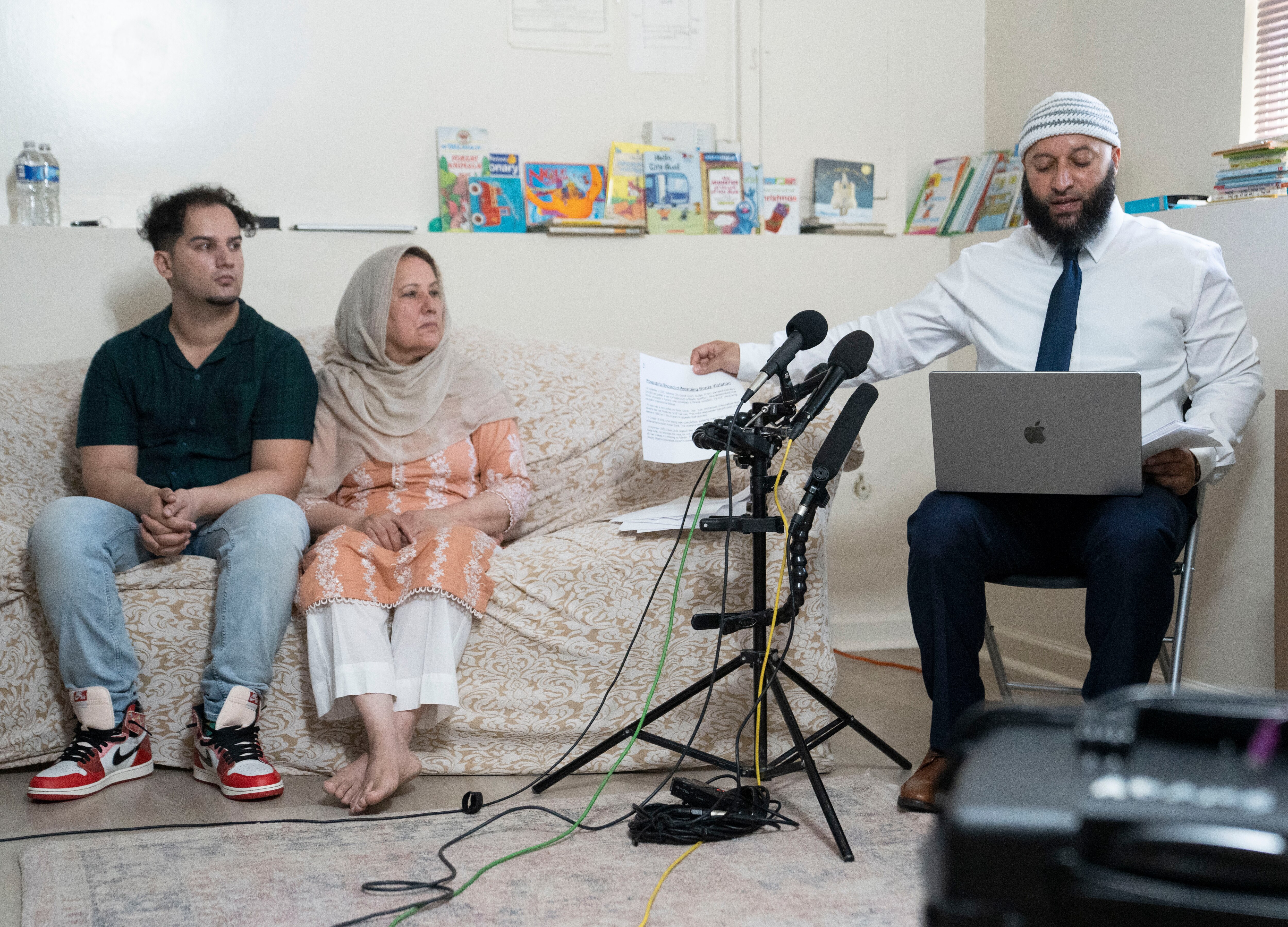 Adnan Syed, right, speaks to reporters while his brother, Yusuf Syed, and mother, Shamim Syed, accompany him in support on Sept. 19, 2023.