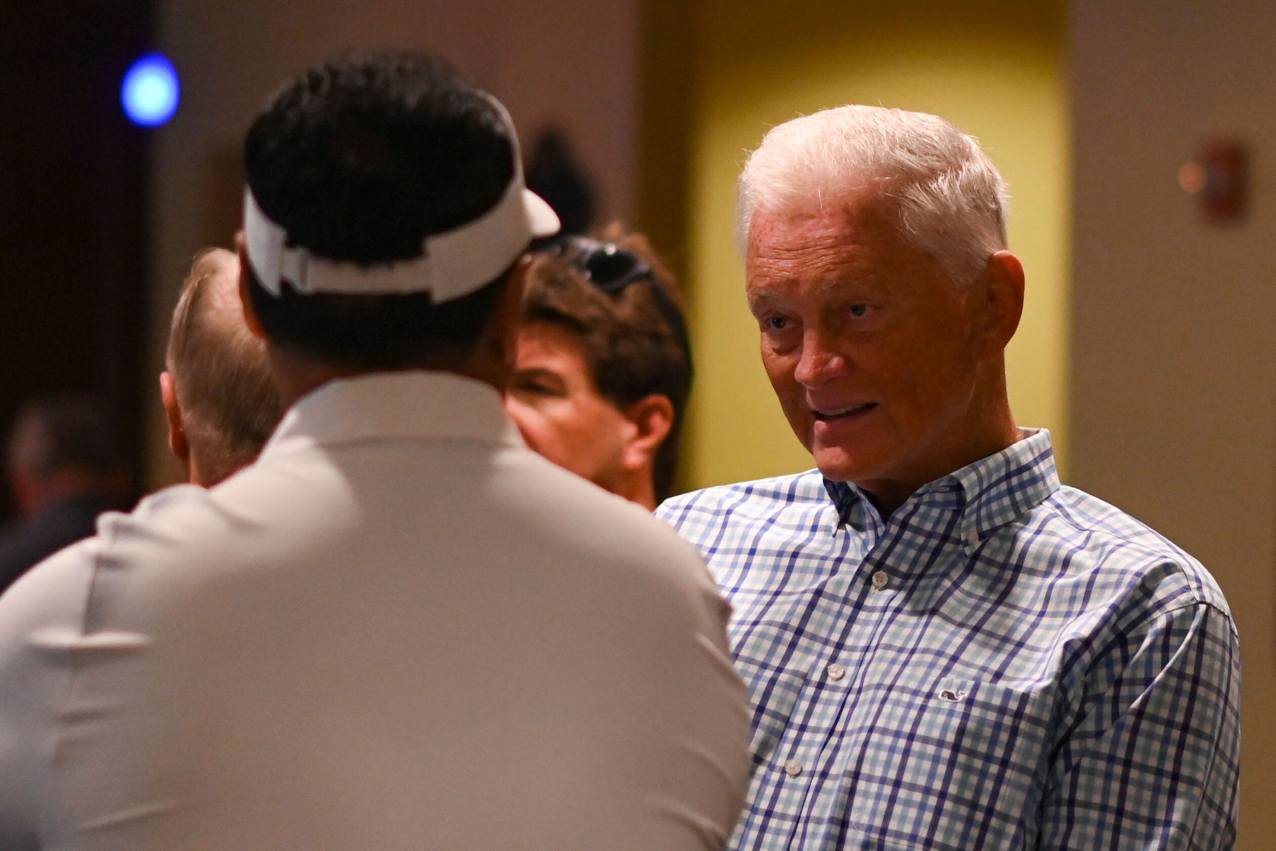 Navy Midshipmen athletic director Chet Gladchuk Jr. speaks with football head coach Ken Niumatalolo during Navy Football Fanfest in 2022.