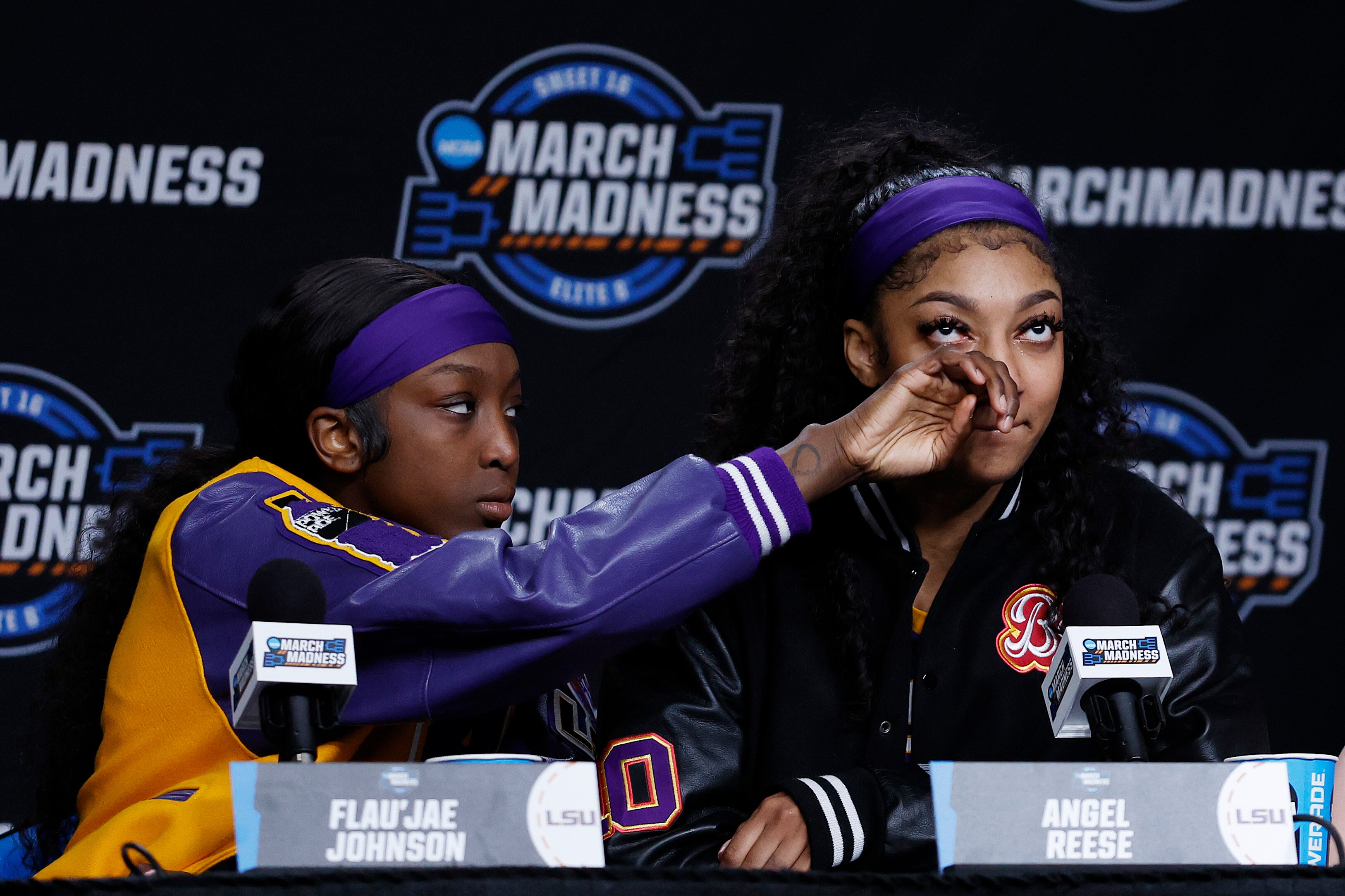 Angel Reese, right, and Flau'jae Johnson of the LSU Tigers speak with the media after losing to the Iowa Hawkeyes in the Elite 8 round of the NCAA Women’s Basketball Tournament at MVP Arena on April 1, 2024 in Albany, New York.
