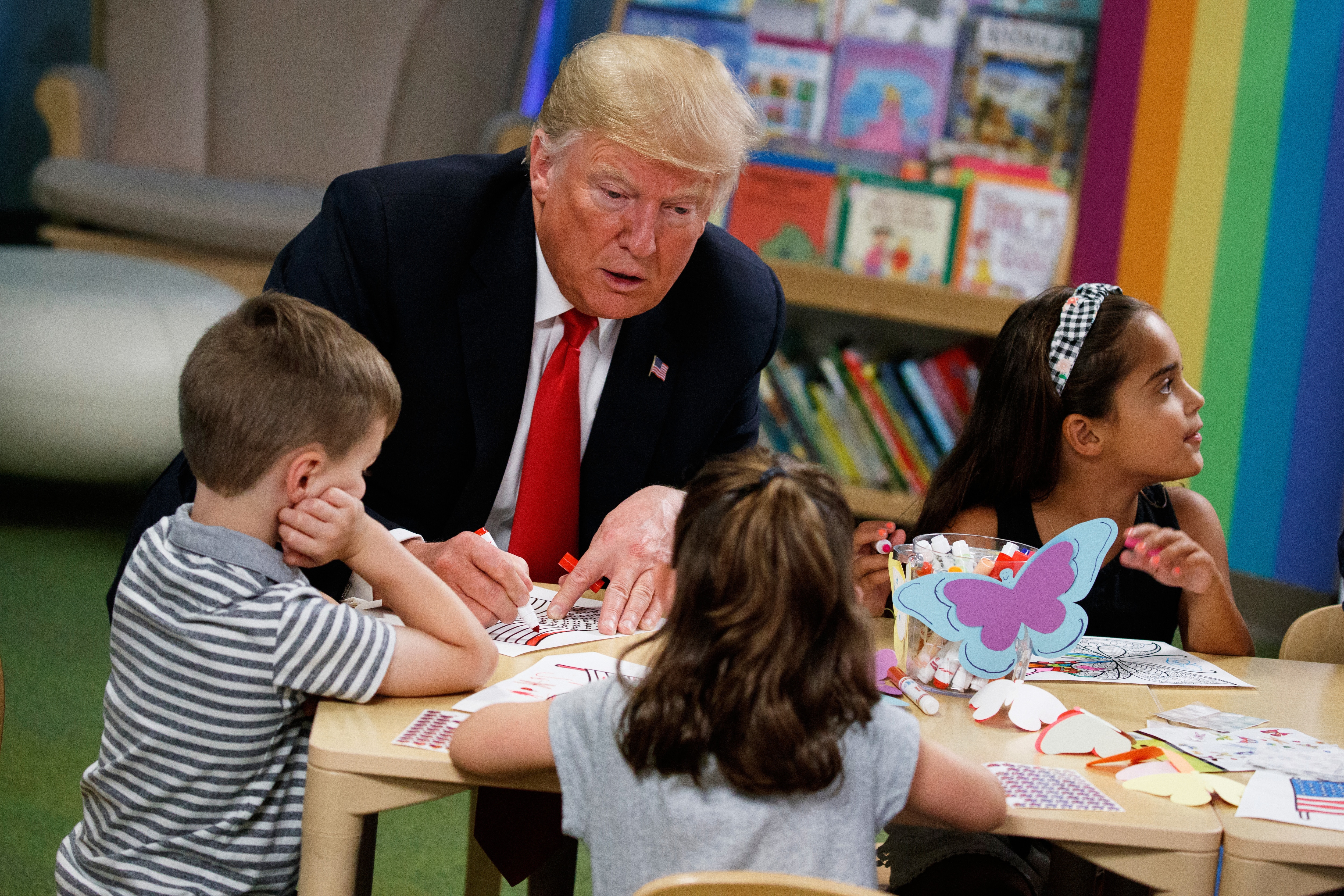 President Donald Trump colors during a visit with a group of children at the Nationwide Children's Hospital, Aug. 24, 2018, in Columbus, Ohio.
