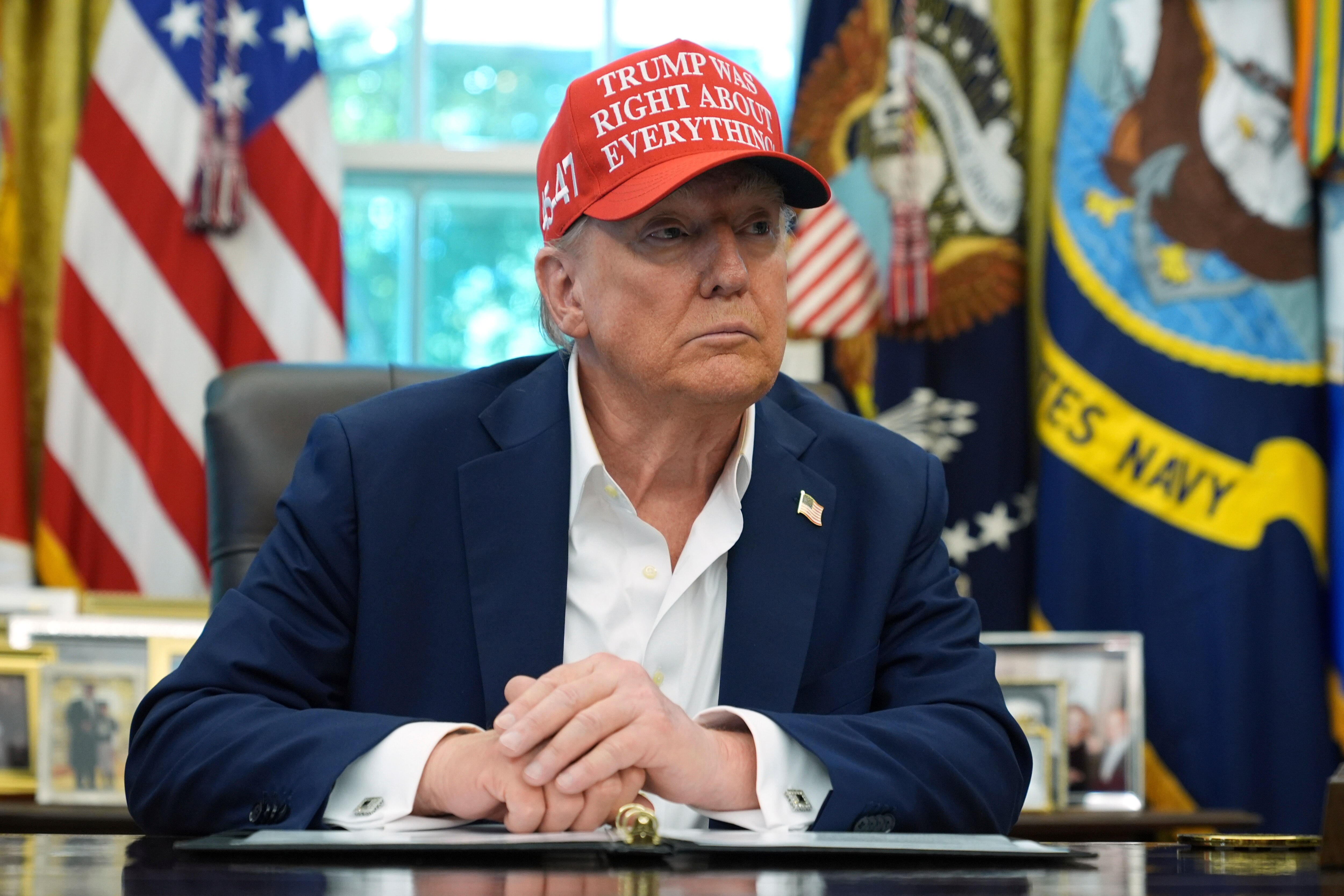 President Donald Trump speaks with reporters in the Oval Office of the White House, Friday, Aug. 22, 2025, in Washington.
