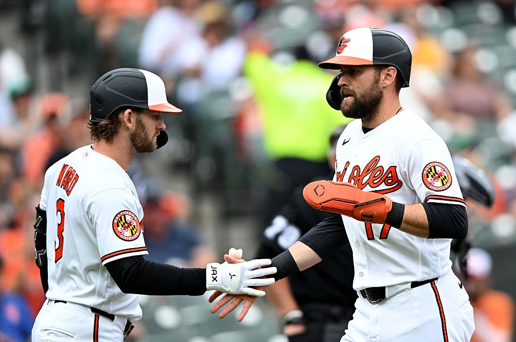 Orioles right fielder Colton Cowser celebrates with designated hitter Taylor Ward after scoring in the second inning against the Texas Rangers.