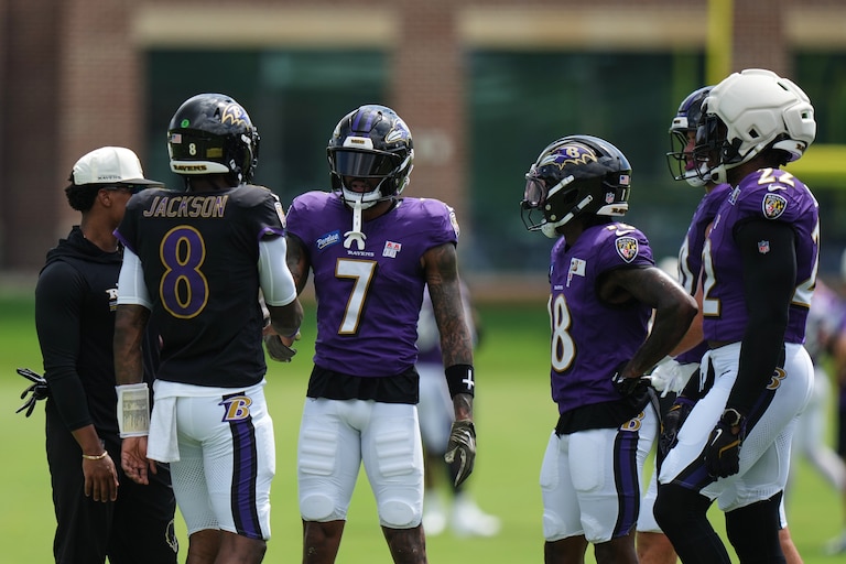 Ravens quarterback Lamar Jackson (8) shakes hands with wide receiver Rashod Bateman (7) during the team's practice Monday.