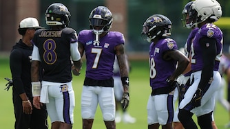 Ravens quarterback Lamar Jackson (8) shakes hands with wide receiver Rashod Bateman (7) during the team's practice Monday.