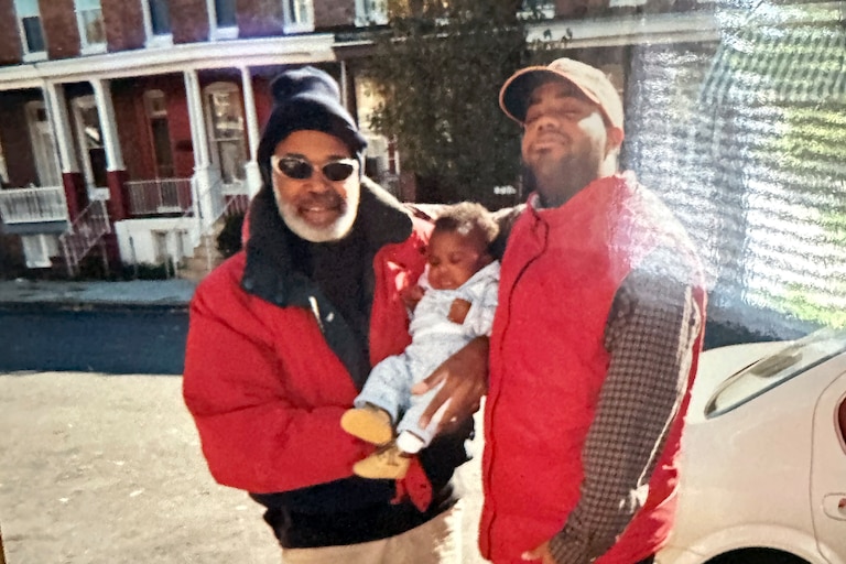 Charles Marks holding his grandson Jason Murphy with his son Woodson Marks.