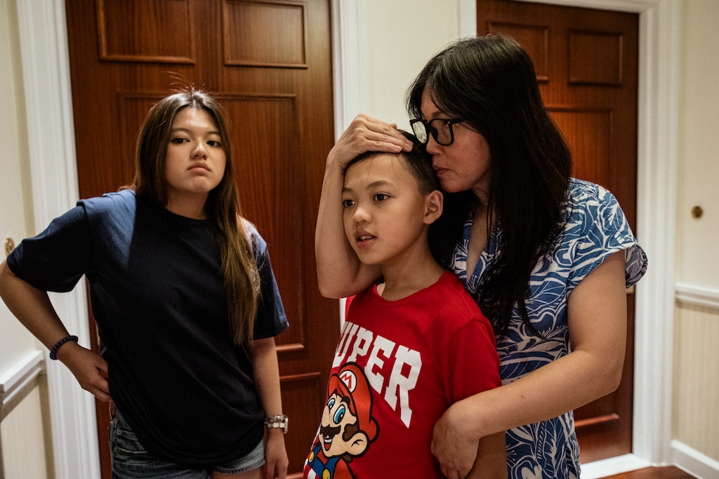 Ho Chi Minh, Vietnam - Aug 6, 2026: Melissa Tran, 44, waits with her children in their hotel room hallway in Ho Chi Minh City, Vietnam on August 6, 2026. Rosem Morton for The Baltimore Banner