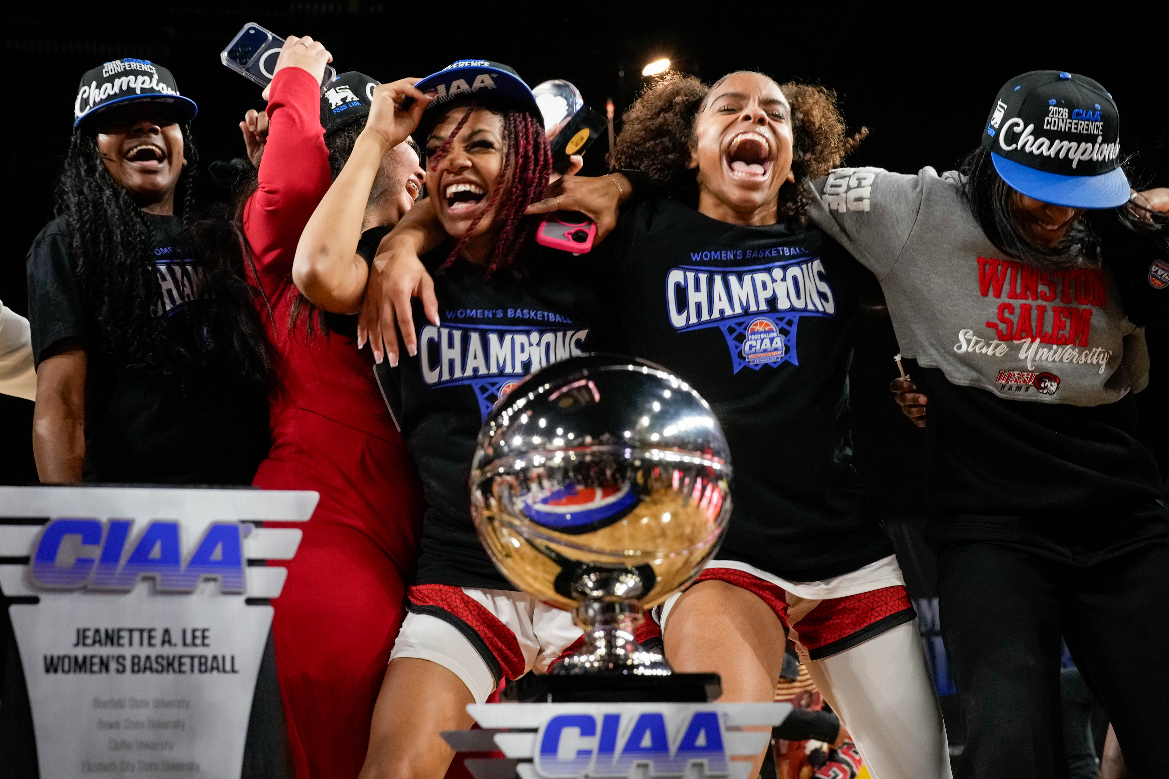 The Winston-Salem State women’s team dances to “Swag Surfin” next to their trophy after defeating Fayetteville State in the CIAA women’s championship game in Baltimore on Saturday.