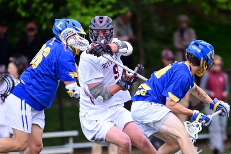 Boys' Latin's Jackson Walsh splits two Loyola defenders during Tuesday's MIAA A Conference lacrosse game. Walsh finished with three goals as the No. 3 Lakers handed the top-ranked Dons their first league loss in a 12-5 decision at J. Duncan Smith Field in Baltimore City.