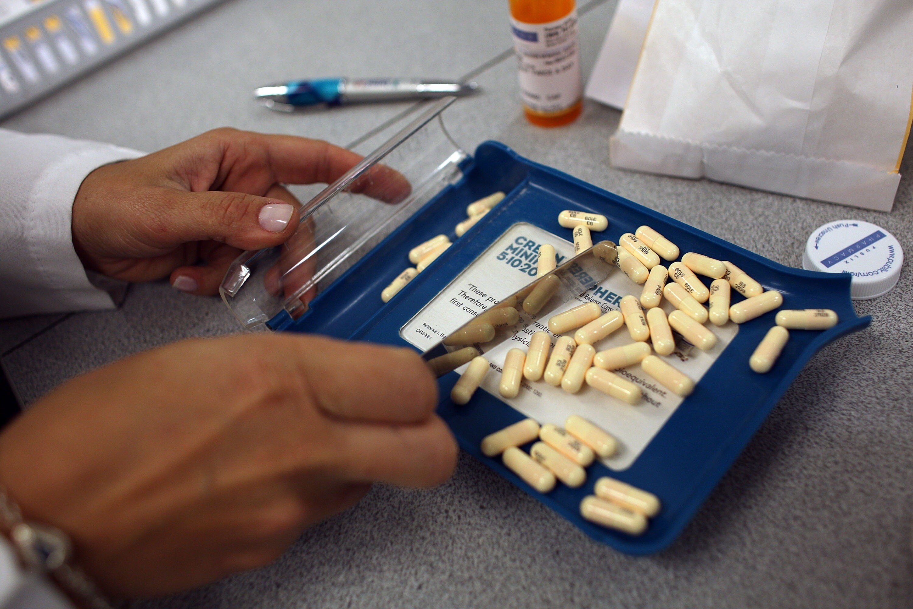 A Miami pharmacist fills a prescription in this 2007 file photo. A Maryland board intended to limit the cost of prescription drugs will issue its first report this week.