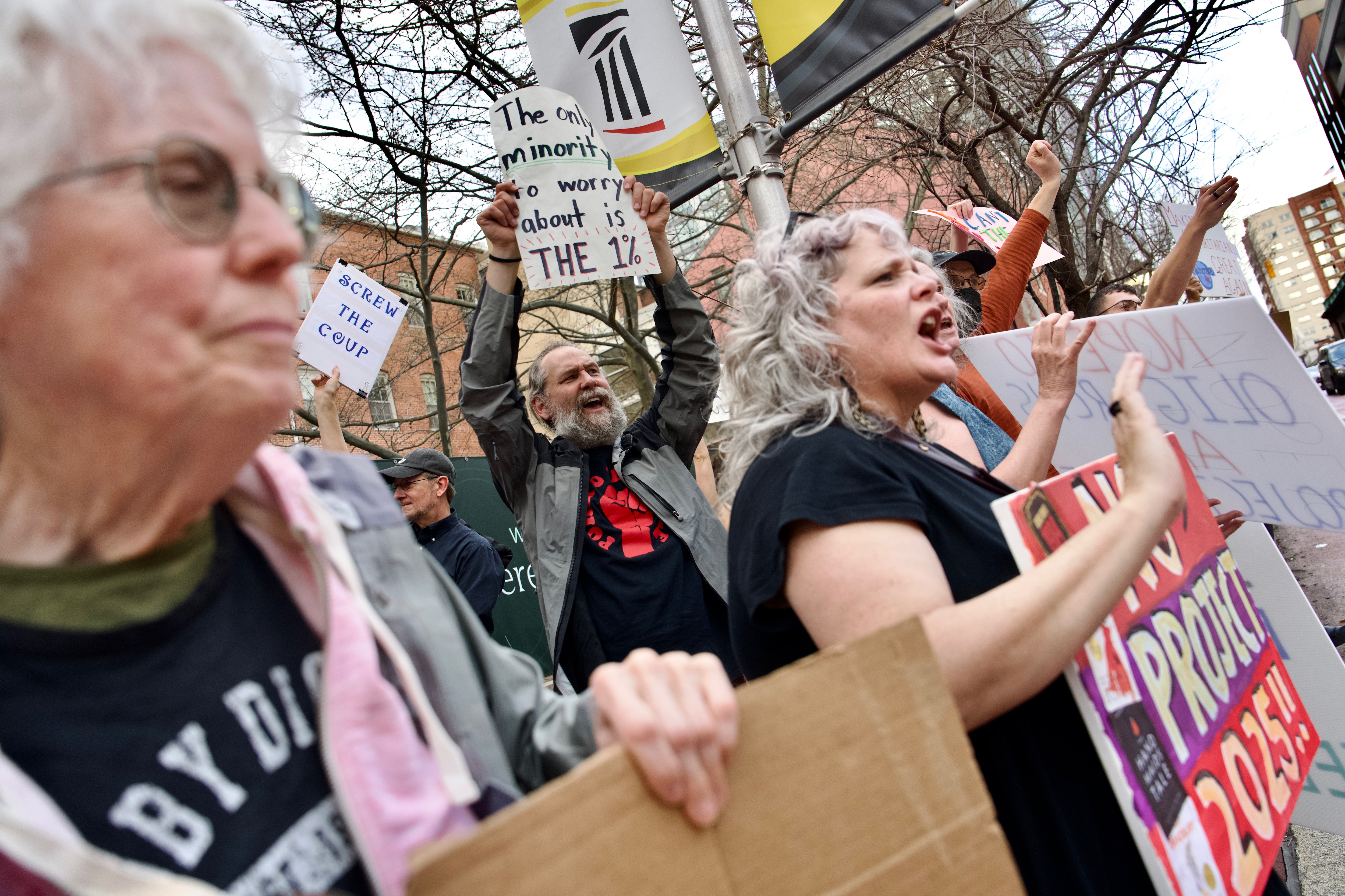 Kat Lally, right, and Kate McAvinue, left, join others as they protest at the University of Maryland Francis King Carey School of Law on Monday.