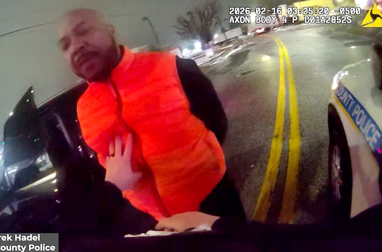 The Maryland Attorney General’s Office released body camera footage showing Samuel “Big Sam” Brown Jr.’s swatting away Baltimore County Police Officer Derek Hadel’s arm twice before he punches Brown twice — knocking him into the asphalt.