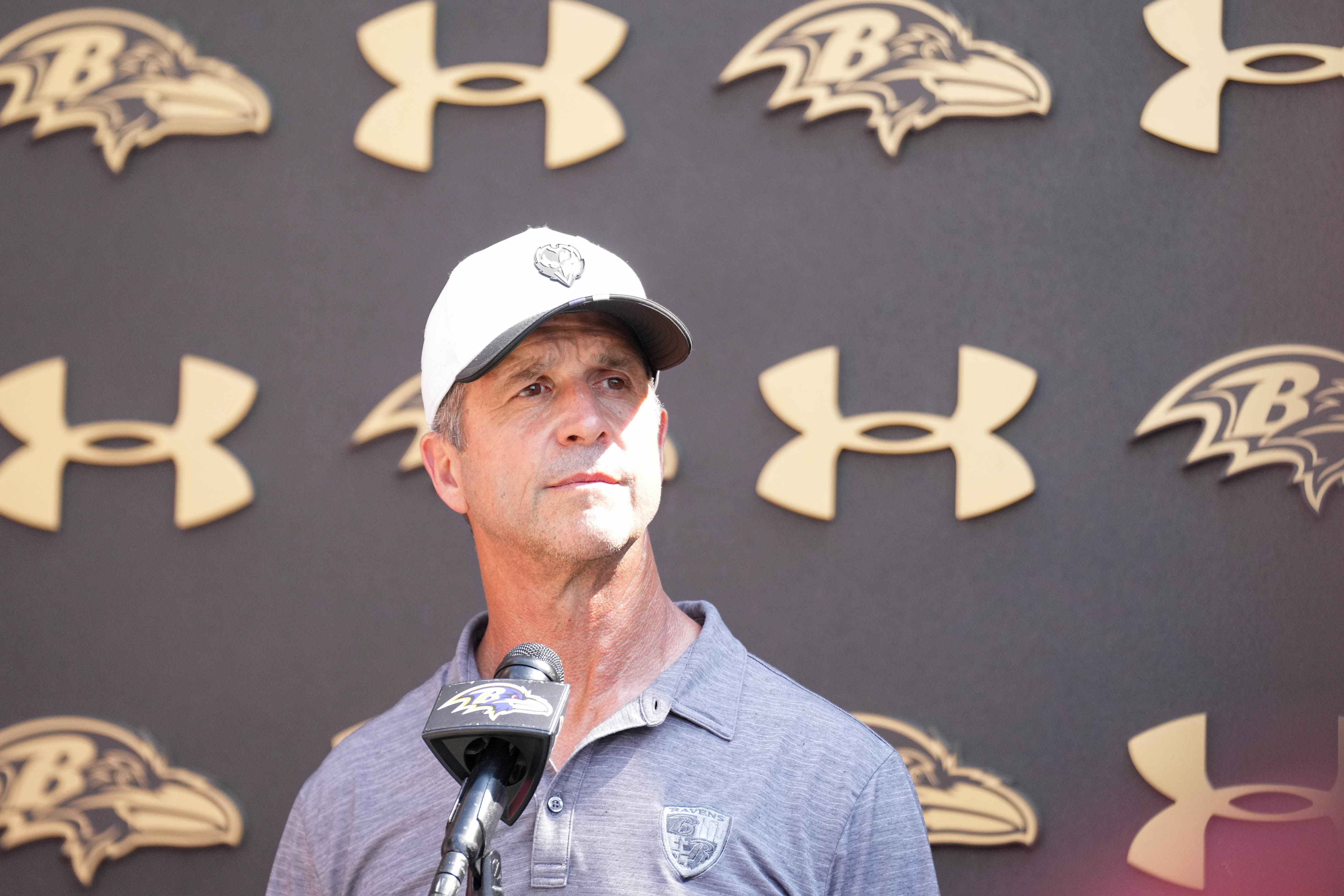 Ravens coach John Harbaugh takes questions from reporters following the team’s training camp session Wednesday in Owings Mills.