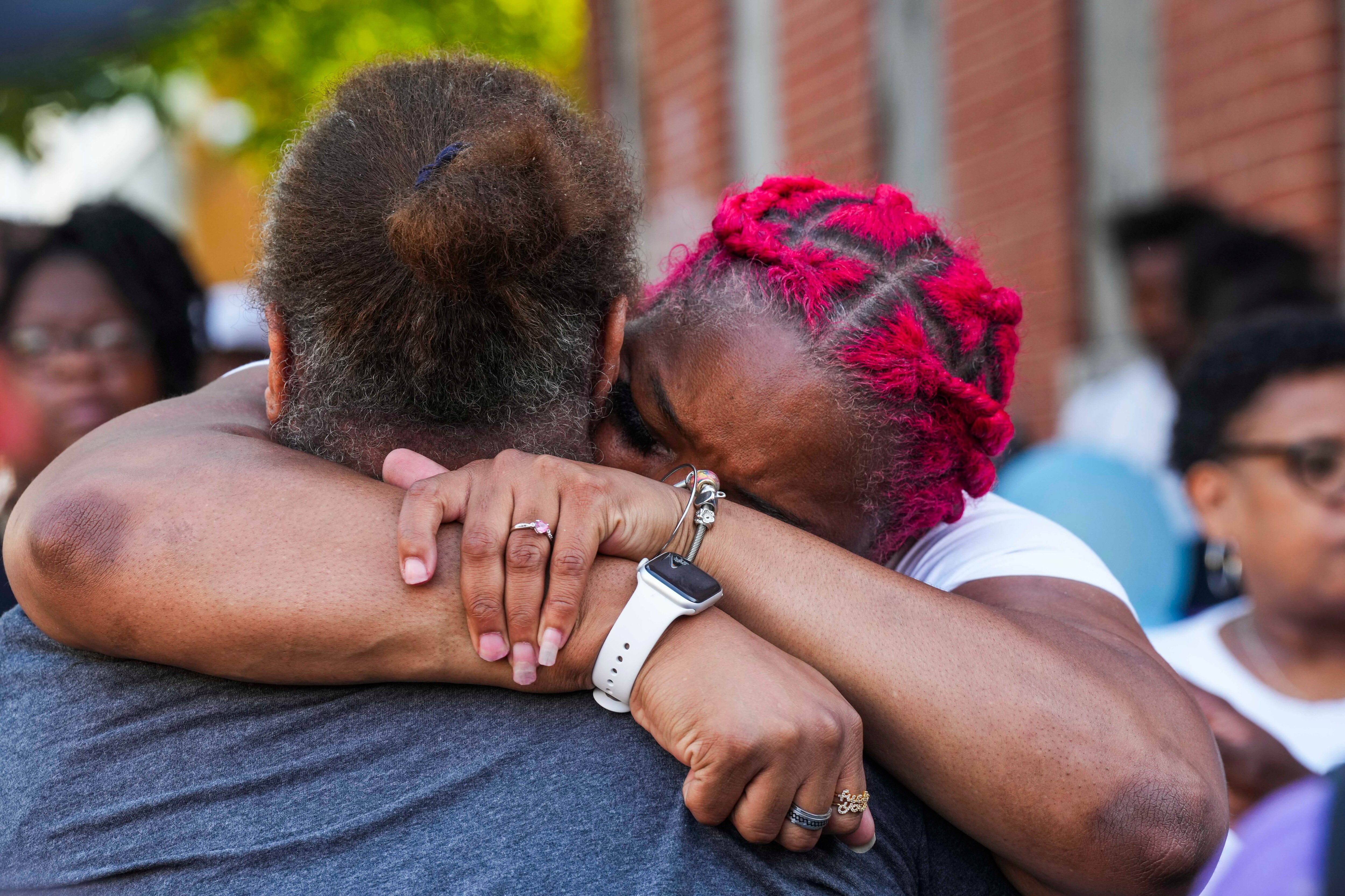 Tamika L, mother of Kylis Fagbemi, 20, is comforted by loved ones at a vigil in honor of Fagbemi on July 11, 2023. 