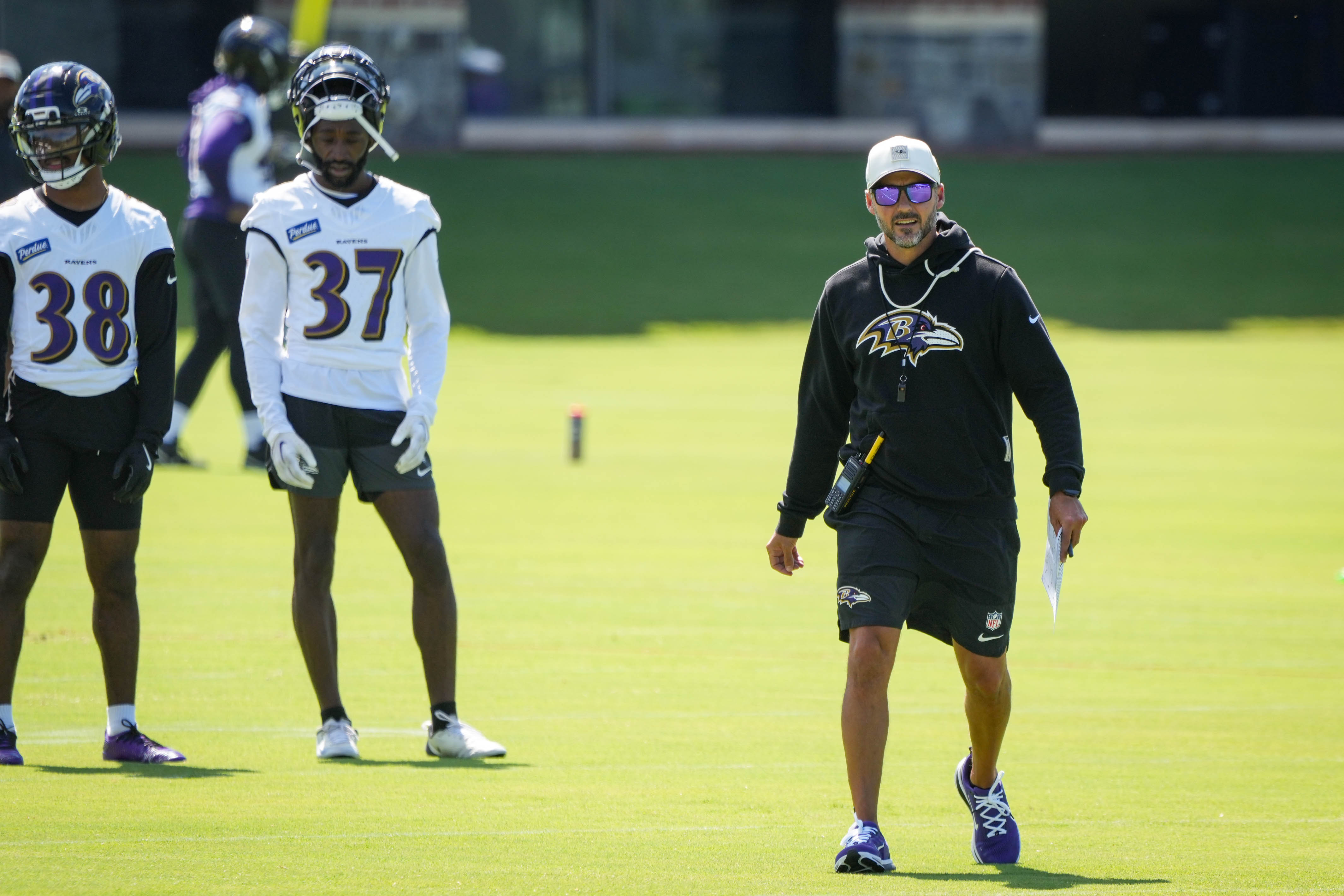 Ravens coach Jesse Minter instructs players about to run a defensive drill during training camp last week.
