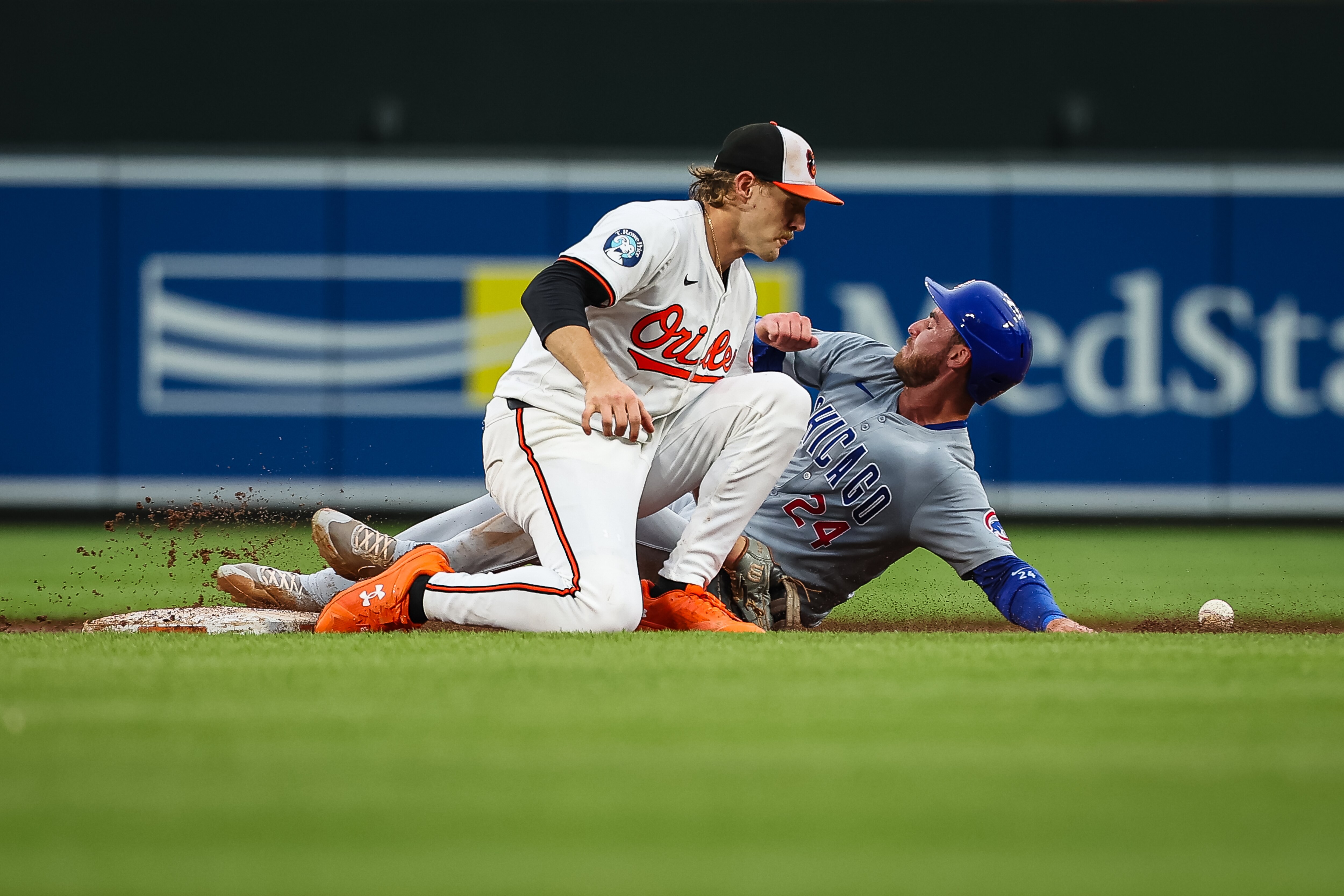 Cody Bellinger of the Chicago Cubs steals second base against as Orioles shortstop Gunnar Henderson tries to field the throw.