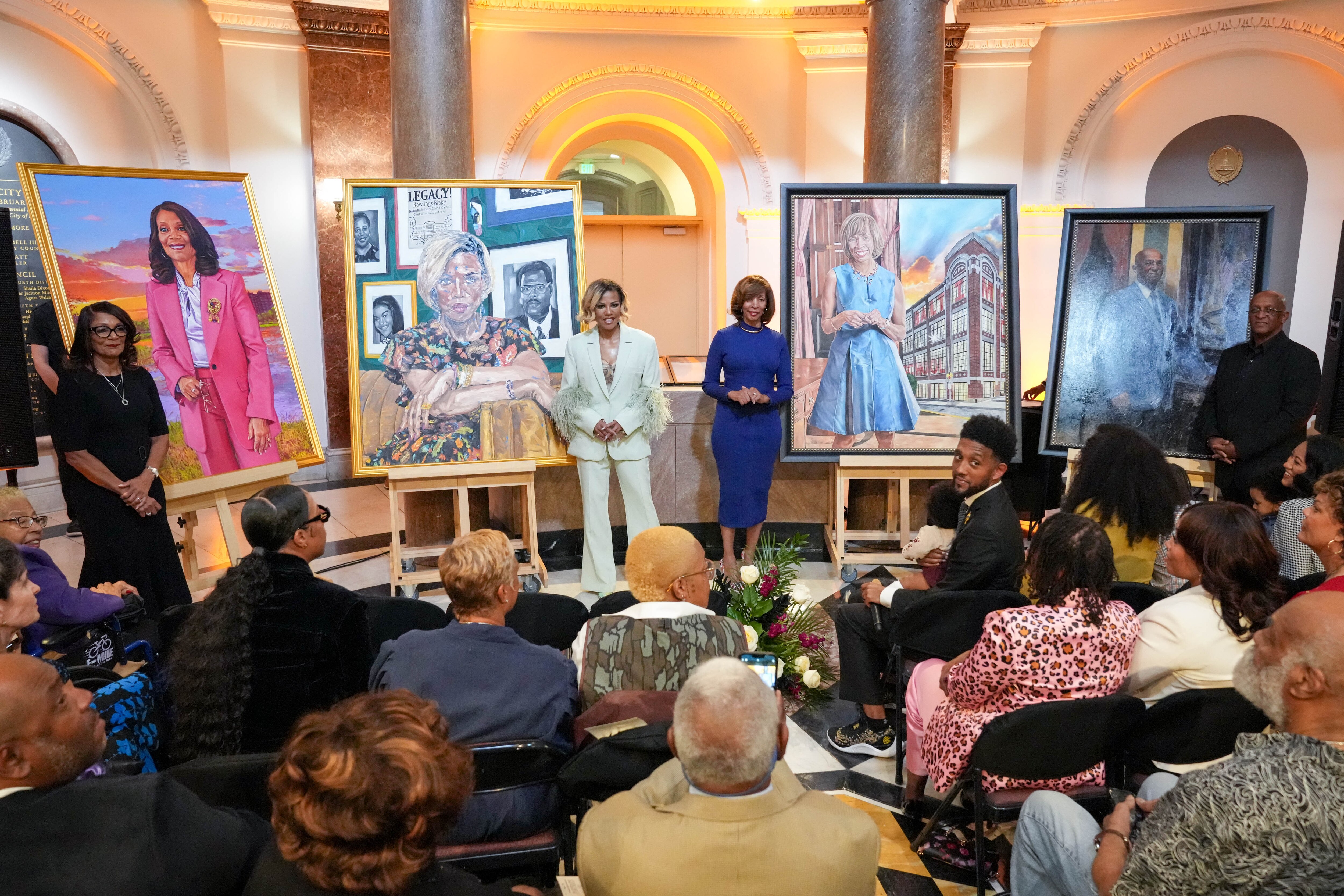 From left: Former mayors Sheila Dixon, Stephanie Rawlings-Blake, Catherine Pugh and Bernard “Jack” Young stand with their portraits during an unveiling ceremony inside City Hall in Baltimore on Saturday.