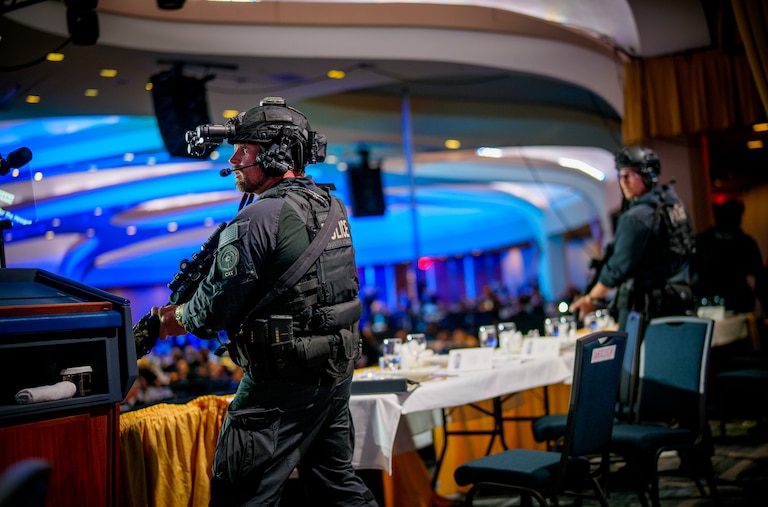 Armed Secret Service agents stand on stage during a shooting incident at the annual White House Correspondents Association Dinner at the Washington Hilton on April 25, 2026 in Washington, DC. According to reports, President Donald Trump, along with other government officials, were evacuated from the Washington Hilton after gun shots.