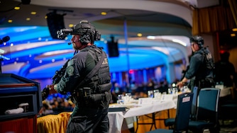 Armed Secret Service agents stand on stage during a shooting incident at the annual White House Correspondents Association Dinner at the Washington Hilton on April 25, 2026 in Washington, DC. According to reports, President Donald Trump, along with other government officials, were evacuated from the Washington Hilton after gun shots.